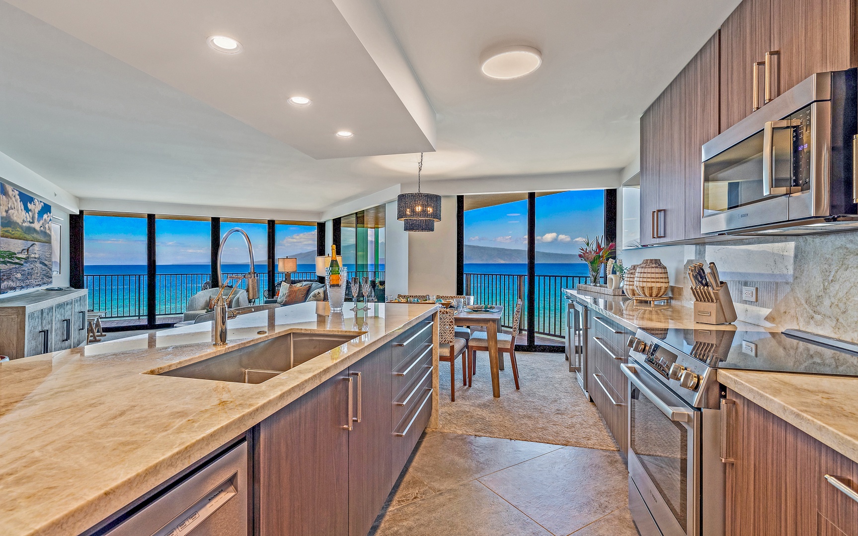 Lahaina Vacation Rentals, Kaanapali Shores 702 - The kitchen offers modern appliances and an island, all while showcasing stunning ocean views through large windows.