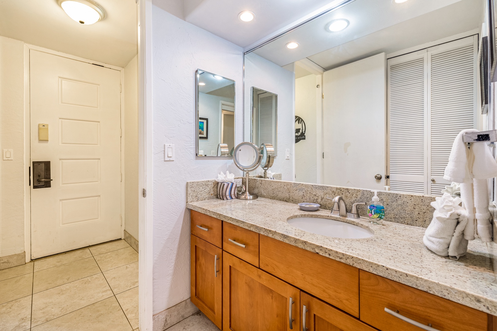 Lahaina Vacation Rentals, Papakea K-105 - The bathroom offers a spacious vanity with ample storage and a well-lit mirror, creating a comfortable space for getting ready each day.