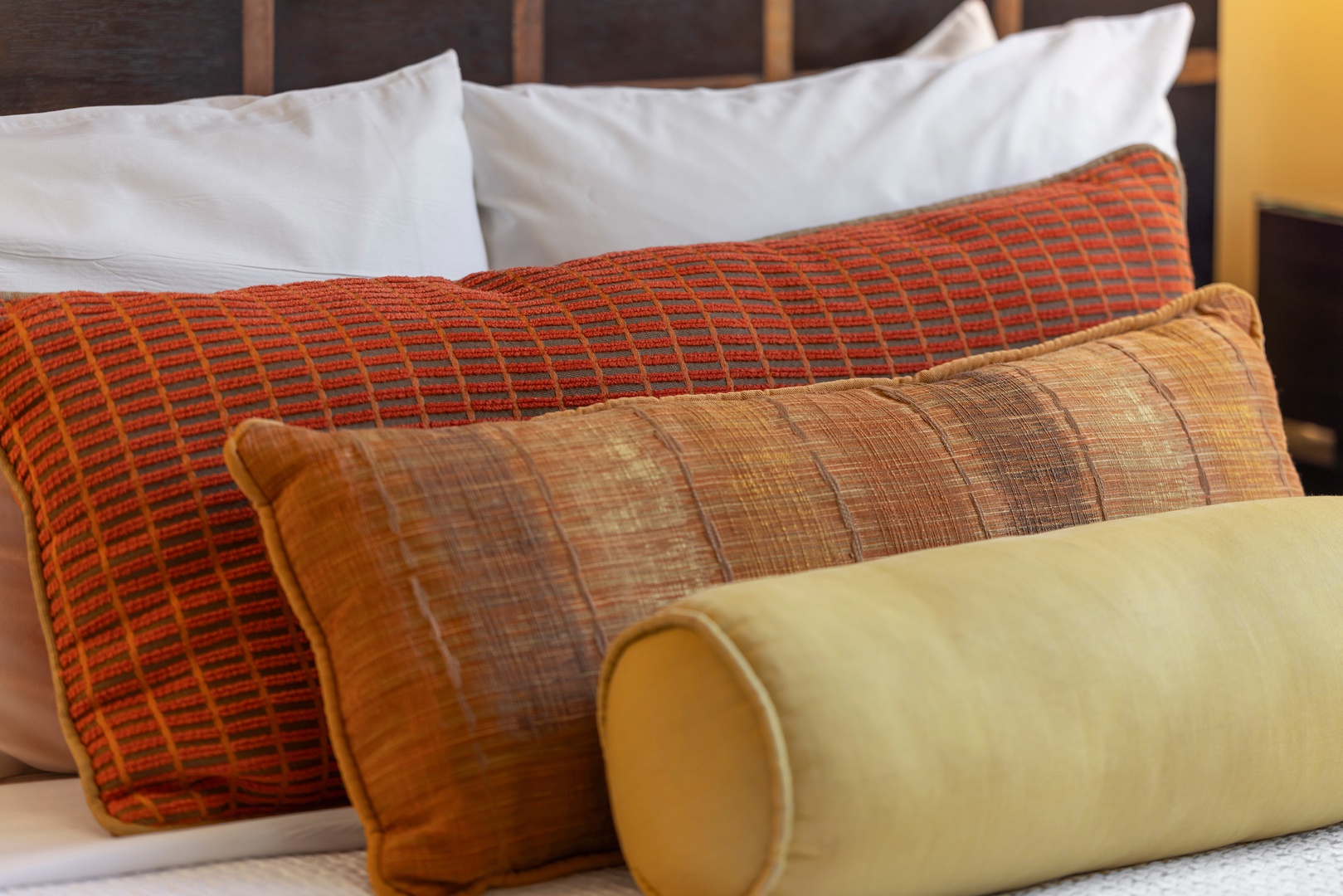 Sink into crisp white linens and plush accent pillows in warm autumn tones—your perfect retreat after a day of exploring awaits.