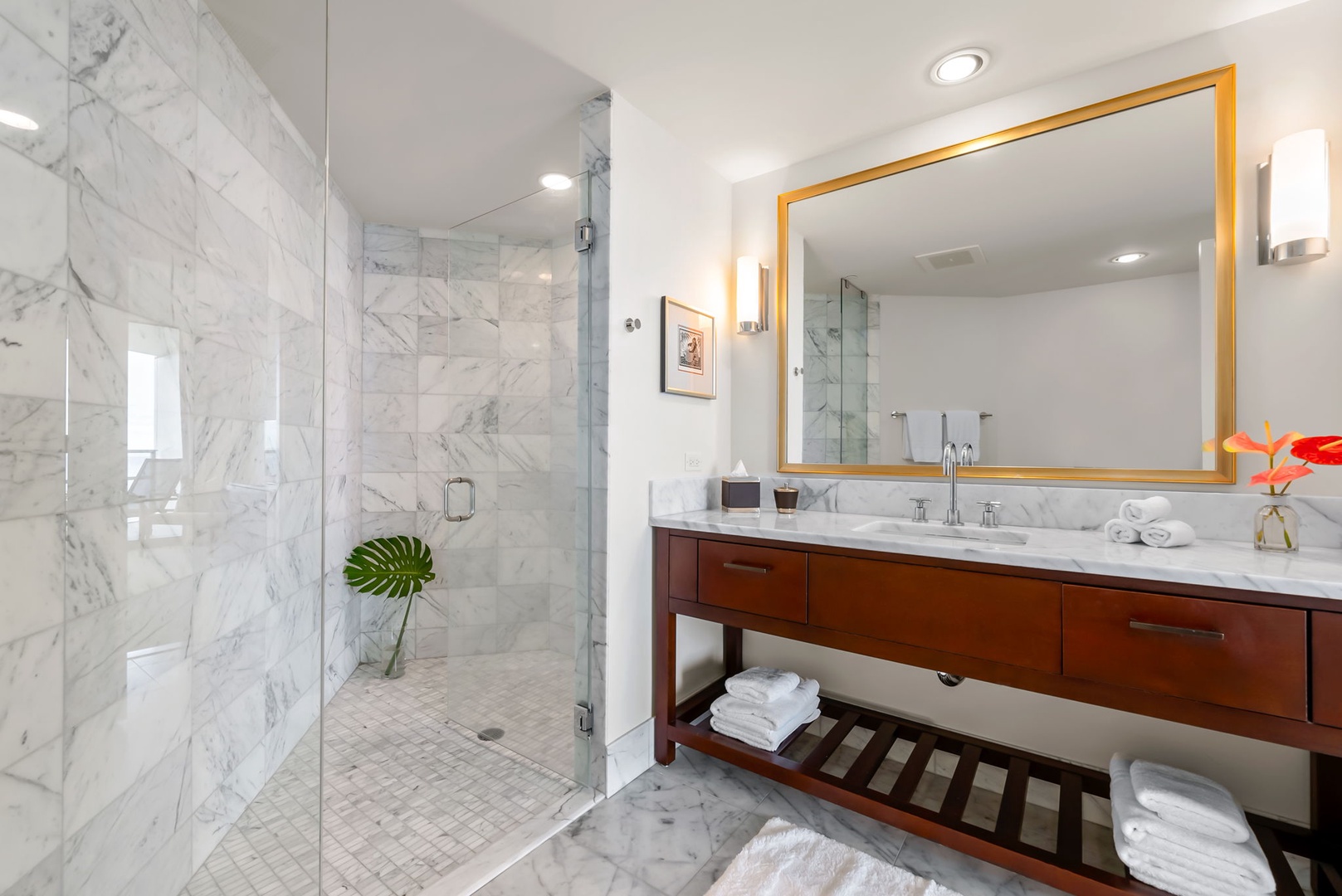 Honolulu Vacation Rentals, Kala'i 3203 - Spacious guest marble bathroom with a sleek glass shower and stylish vanity.