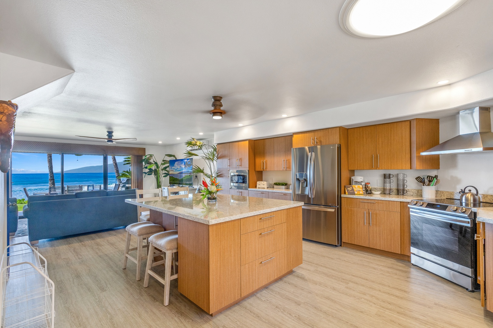 Lahaina Vacation Rentals, Puamana 254-2 - Puamana 254-2’s kitchen offers stainless steel appliances and open views to the lanai.