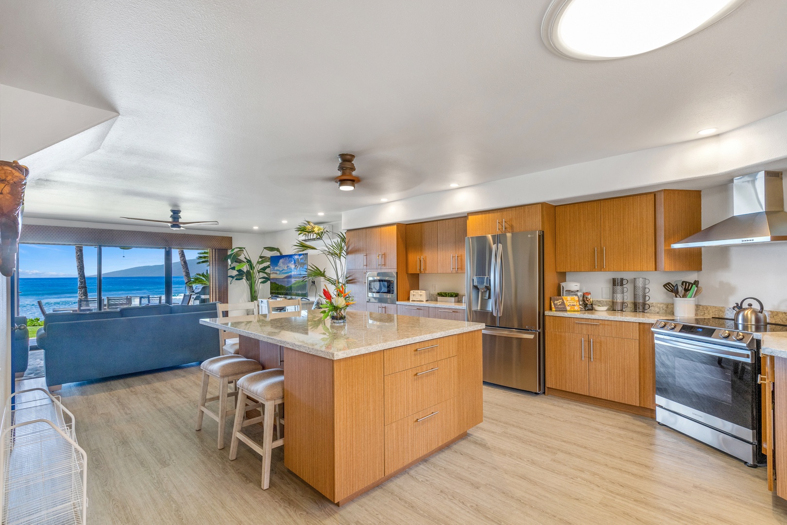 Lahaina Vacation Rentals, Puamana 254-2 - The kitchen features stainless steel appliances and open concept space, featuring the views of the lanai and beyond.