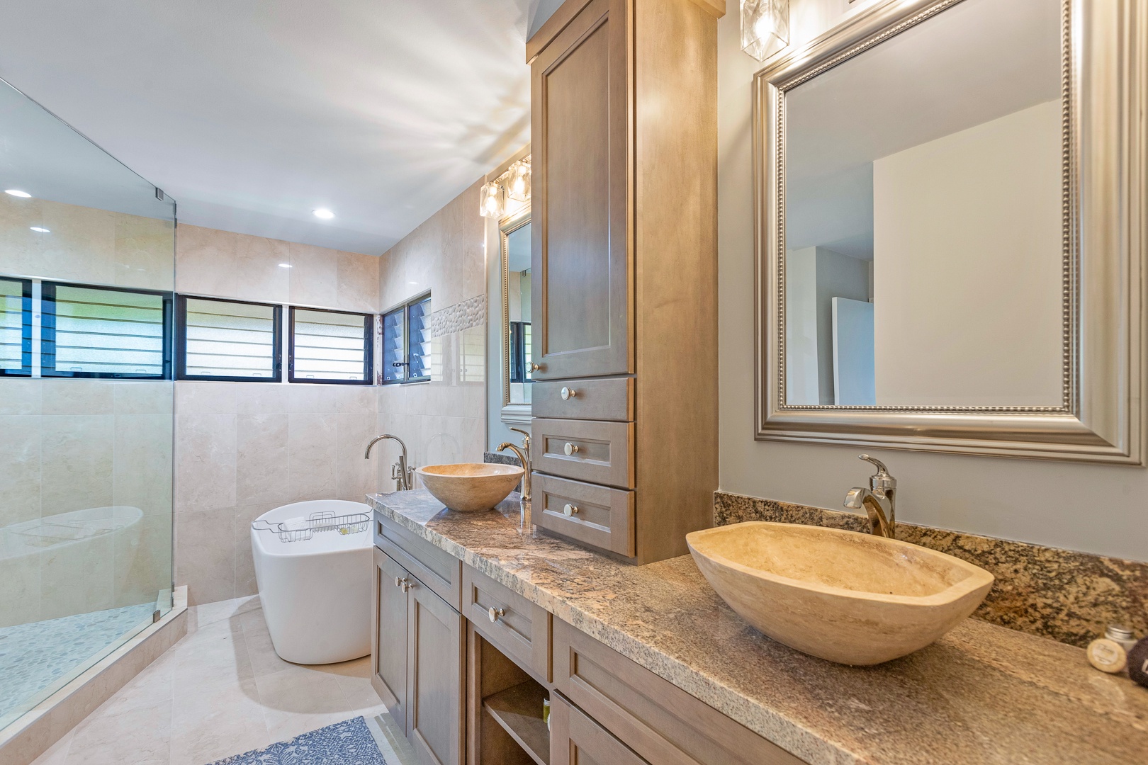 Lahaina Vacation Rentals, Kapalua Ridge 1622 - The luxurious bathroom features dual stone vessel sinks and a spacious vanity area, complemented by a modern standalone soaking tub