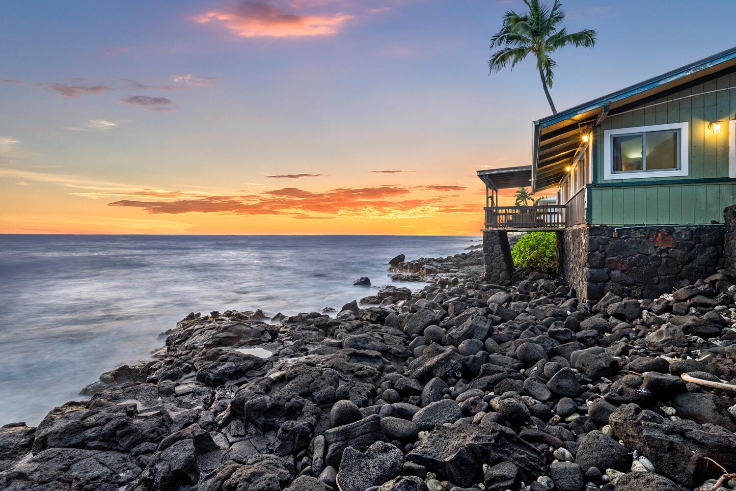 Kailua Kona Vacation Rentals, The Cottage - Dramatic oceanfront views with waves meeting the rugged lava rock at golden hour.