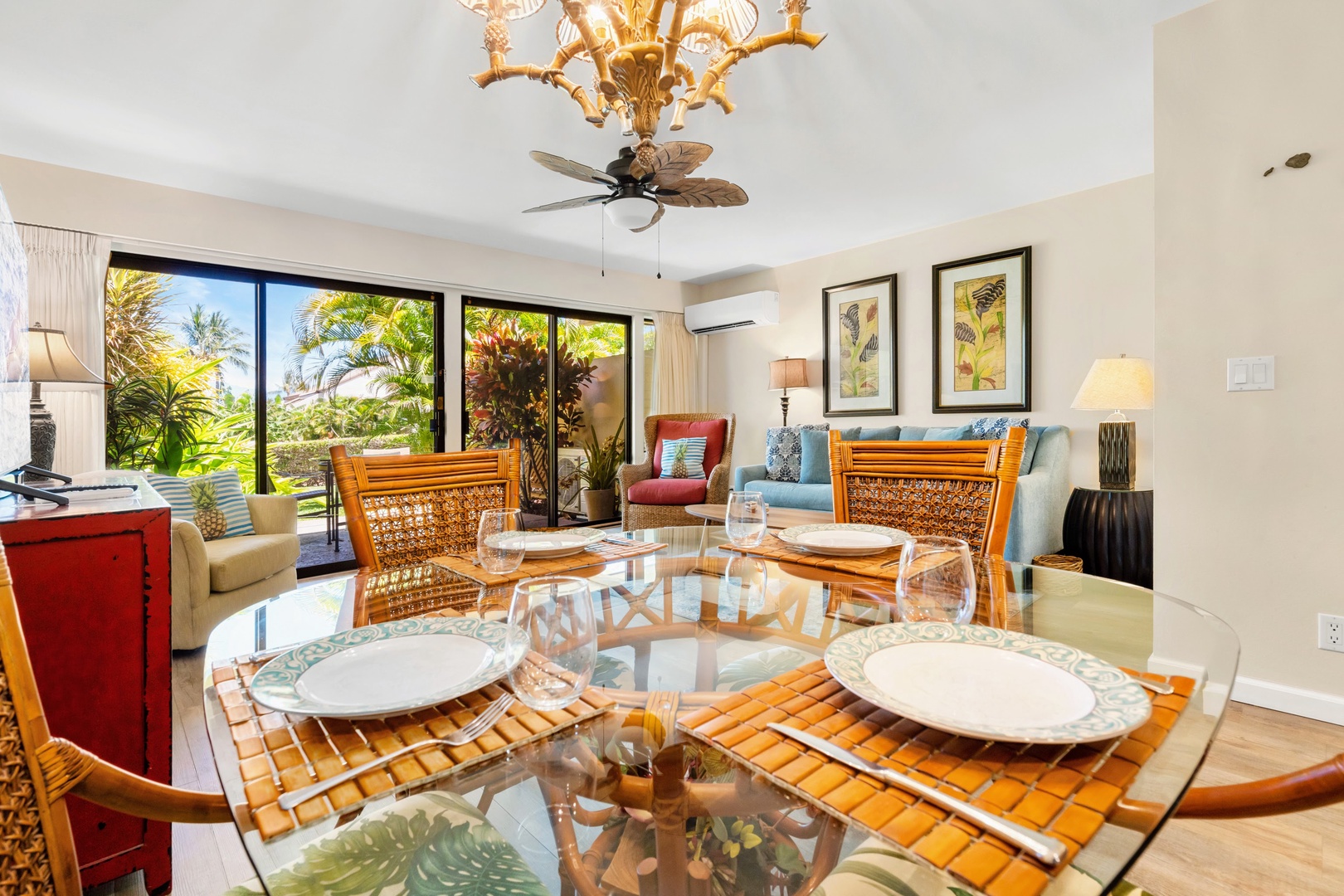 Kihei Vacation Rentals, Maui Kamaole E103 - Pull up a chair at the glass dining table, set for four with the lanai just beyond it.