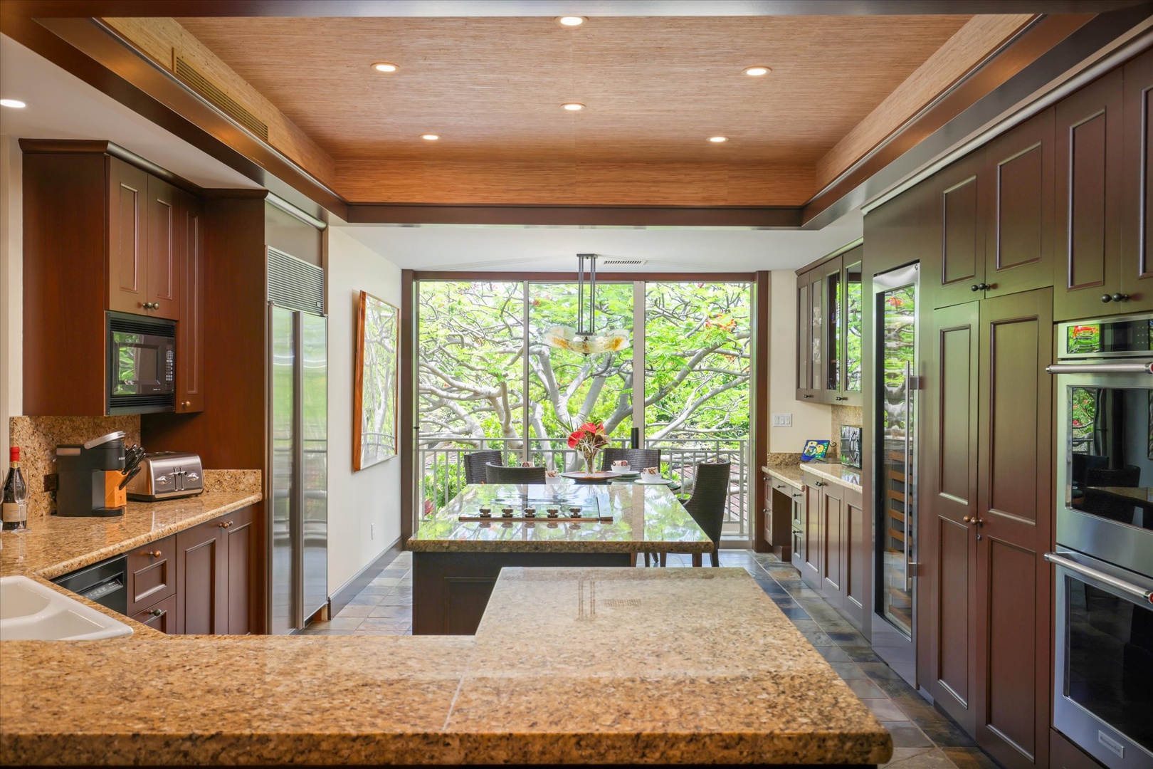 Kailua Kona Vacation Rentals, Wai'ulu Villa 115D - Tranquil reading or breakfast nook with lush garden backdrop—peaceful mornings start here.