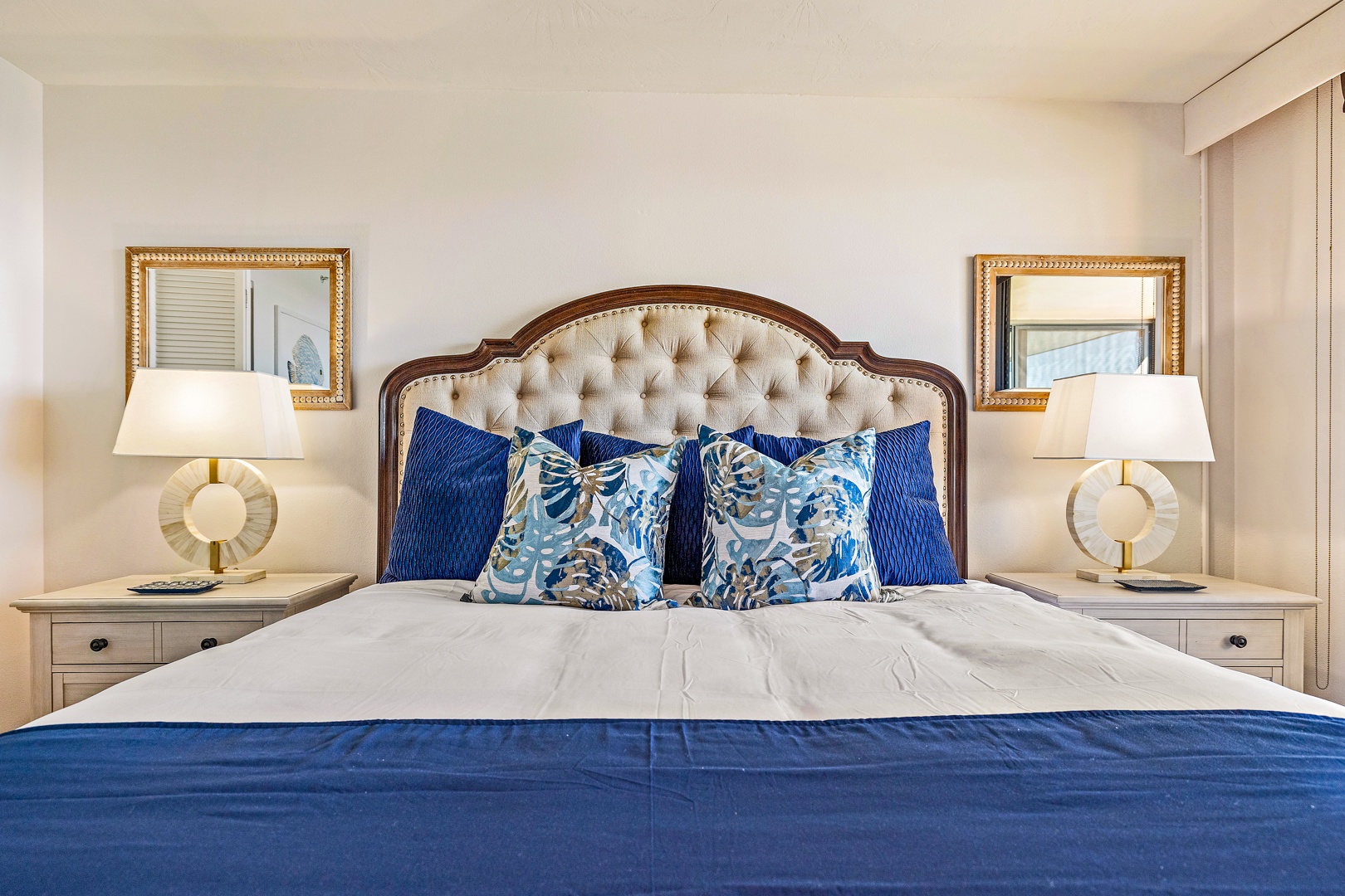 Lahaina Vacation Rentals, Mahana 1118 - The plush king bed in the primary bedroom invites restful nights with its stylish tufted headboard and soothing blue accents