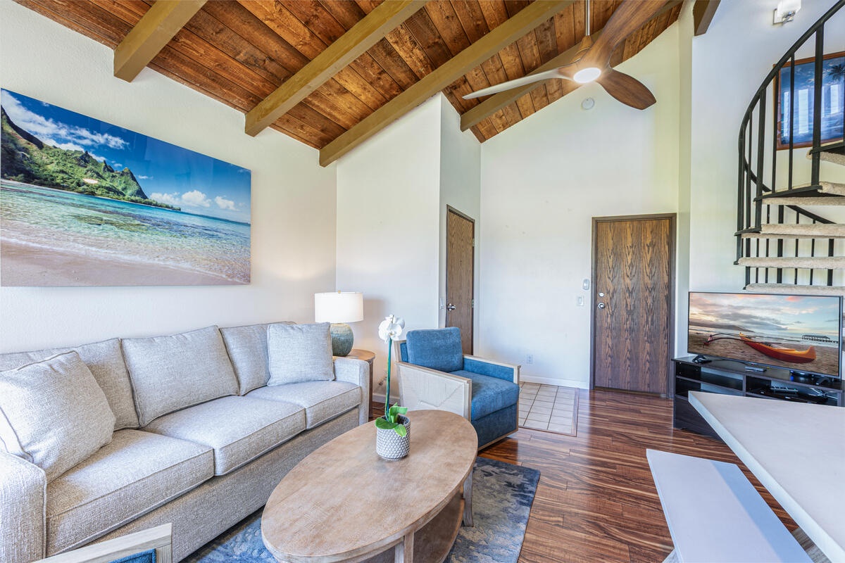 Princeville Vacation Rentals, Hale Ohana Ho'omaka - Comfortable living room with vaulted ceilings and cozy seating. Perfect for relaxing after a day at the beach.
