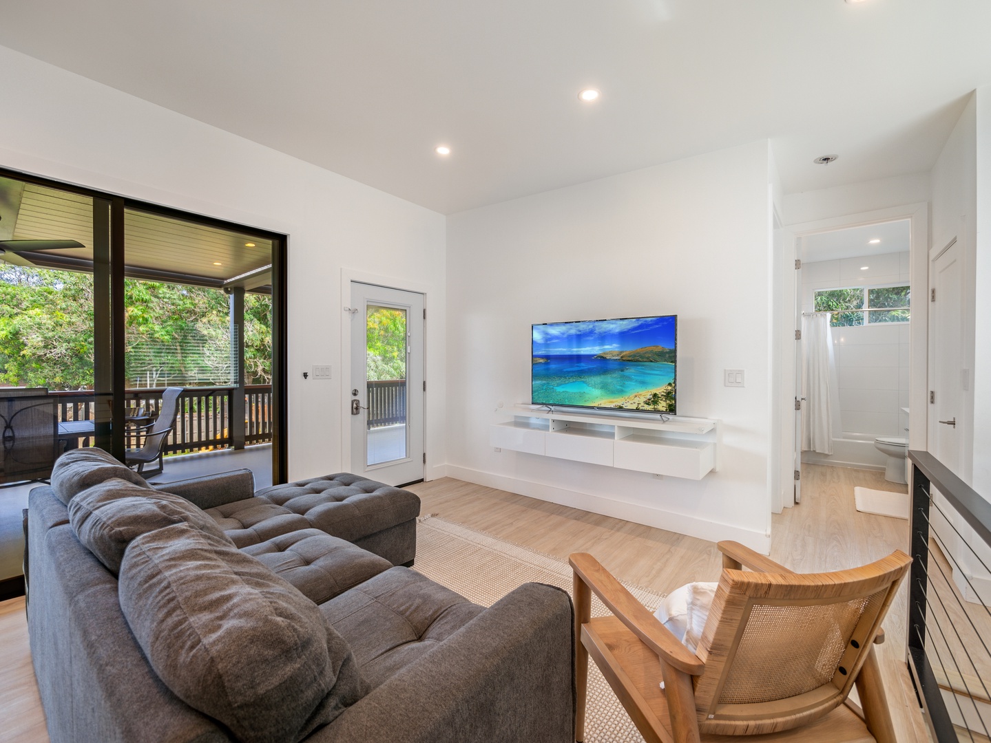 Haleiwa Vacation Rentals, Sunset Beach Island Retreat - The living area offers a cozy sectional and a large flat-screen TV, perfect for unwinding after a day of adventure