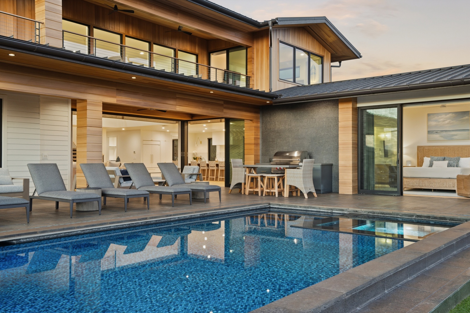 Koloa Vacation Rentals, Hale Laule'a at Kukui'ula - Modern luxury home featuring a sparkling pool, hot tub, outdoor dining area, and seamless indoor-outdoor living spaces with contemporary architecture.