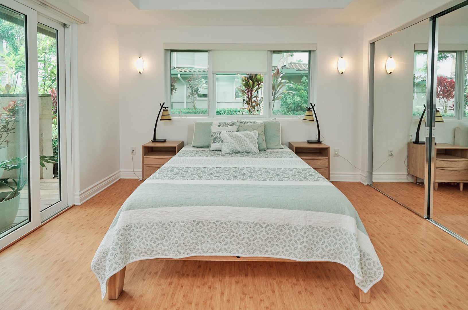 Princeville Vacation Rentals, Hale Kai - Your serene bedroom sanctuary features elegant mirrored closets and garden views from every window, creating peaceful mornings filled with natural light.
