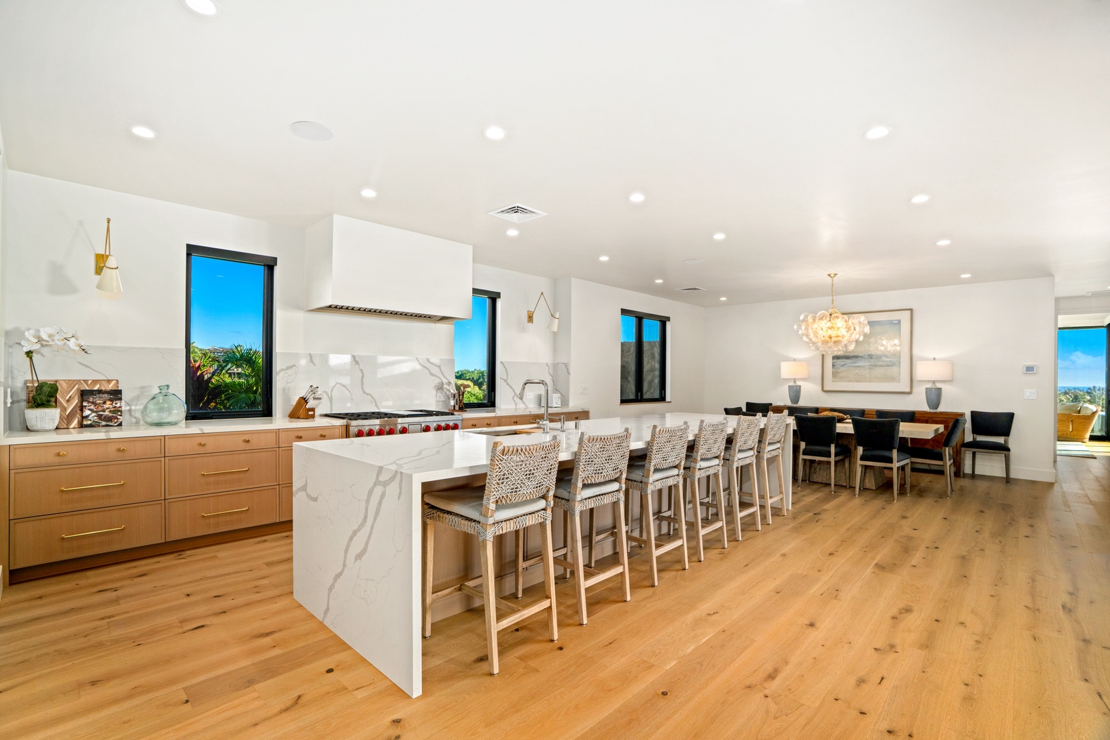 Koloa Vacation Rentals, Hale Laule'a at Kukui'ula - Your stunning open-concept kitchen flows seamlessly into the dining area, featuring a quartz waterfall island perfect for morning coffee and evening conversations.