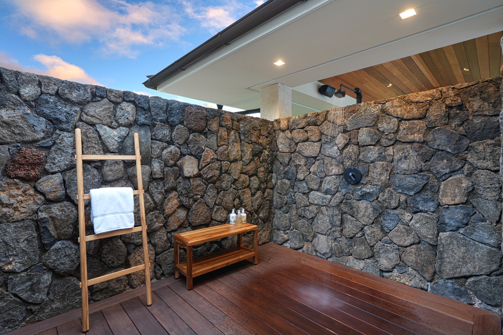 Koloa Vacation Rentals, Hale Kai‘opua at Kukui'ula - Outdoor shower with a natural stone wall, perfect for rinsing off after a swim.