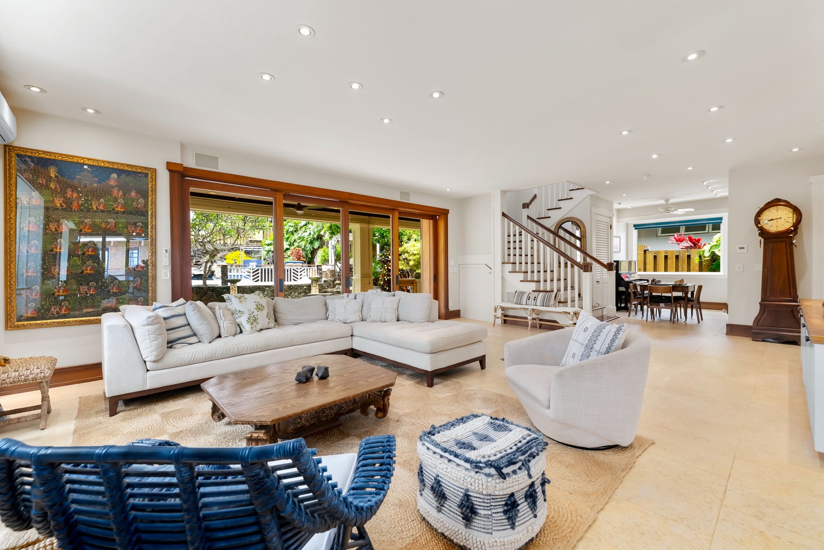 Kailua Vacation Rentals, Leaf House - Step into your elegant living room where natural light pours through expansive windows, plush seating invites relaxation, and a staircase leads to peaceful retreats upstairs.