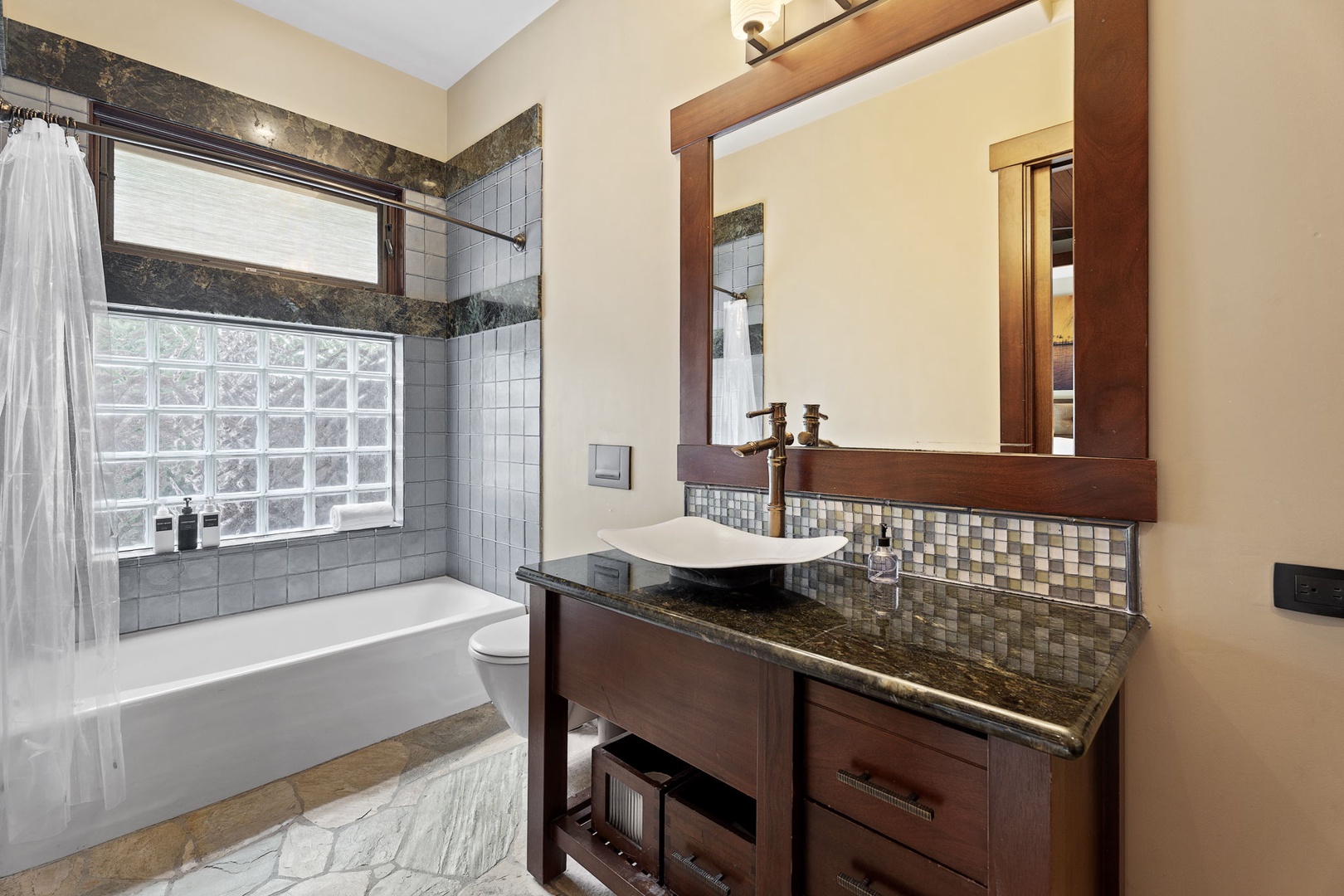 Kamuela Vacation Rentals, Hale Konane - Luxurious ensuite bathroom with spa-like ambiance, a soaking tub, and upscale vanity finishes.