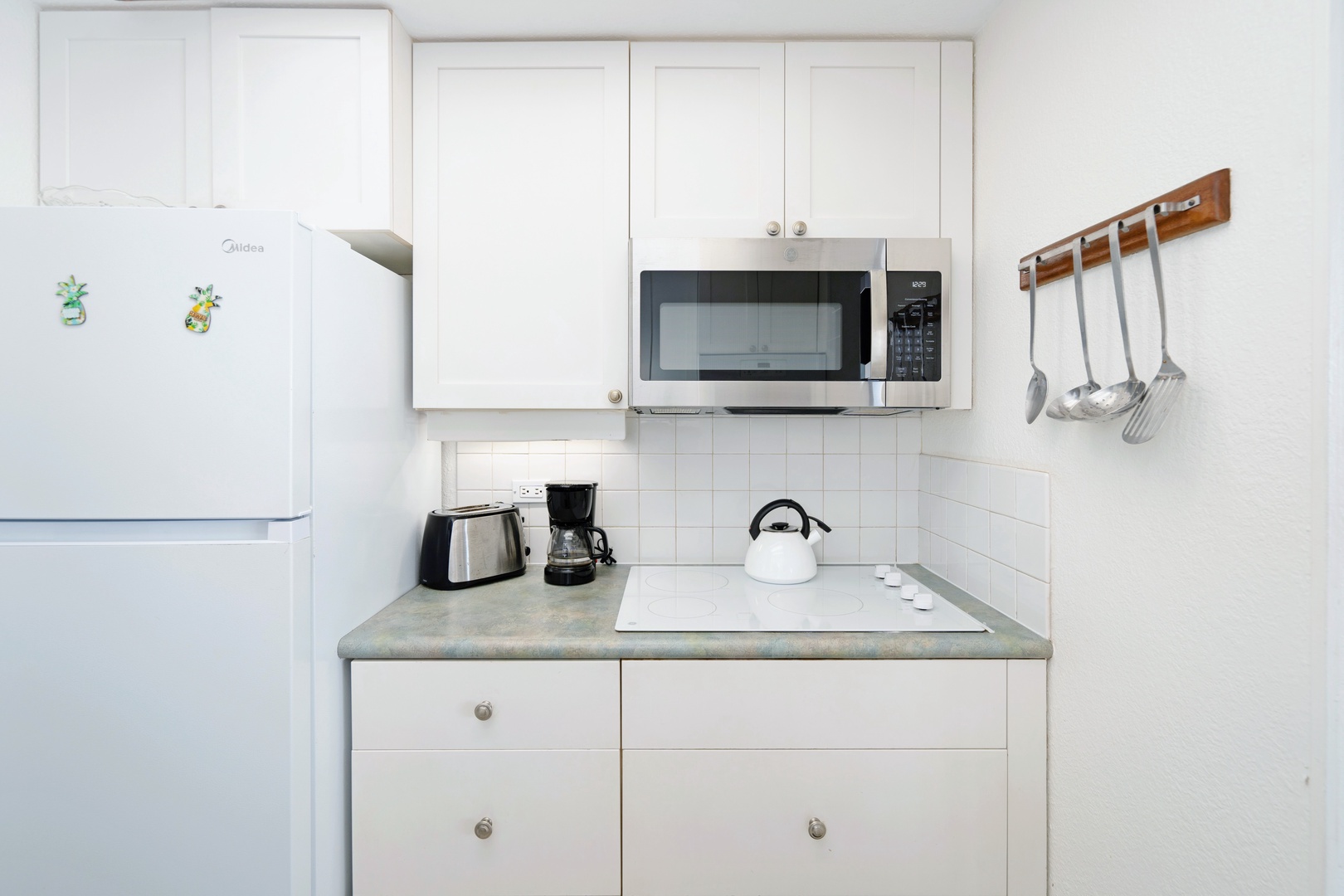 Kihei Vacation Rentals, Punahoa Beach 205 - Coffee maker and kettle stand ready on the counter for the first cup of the morning.