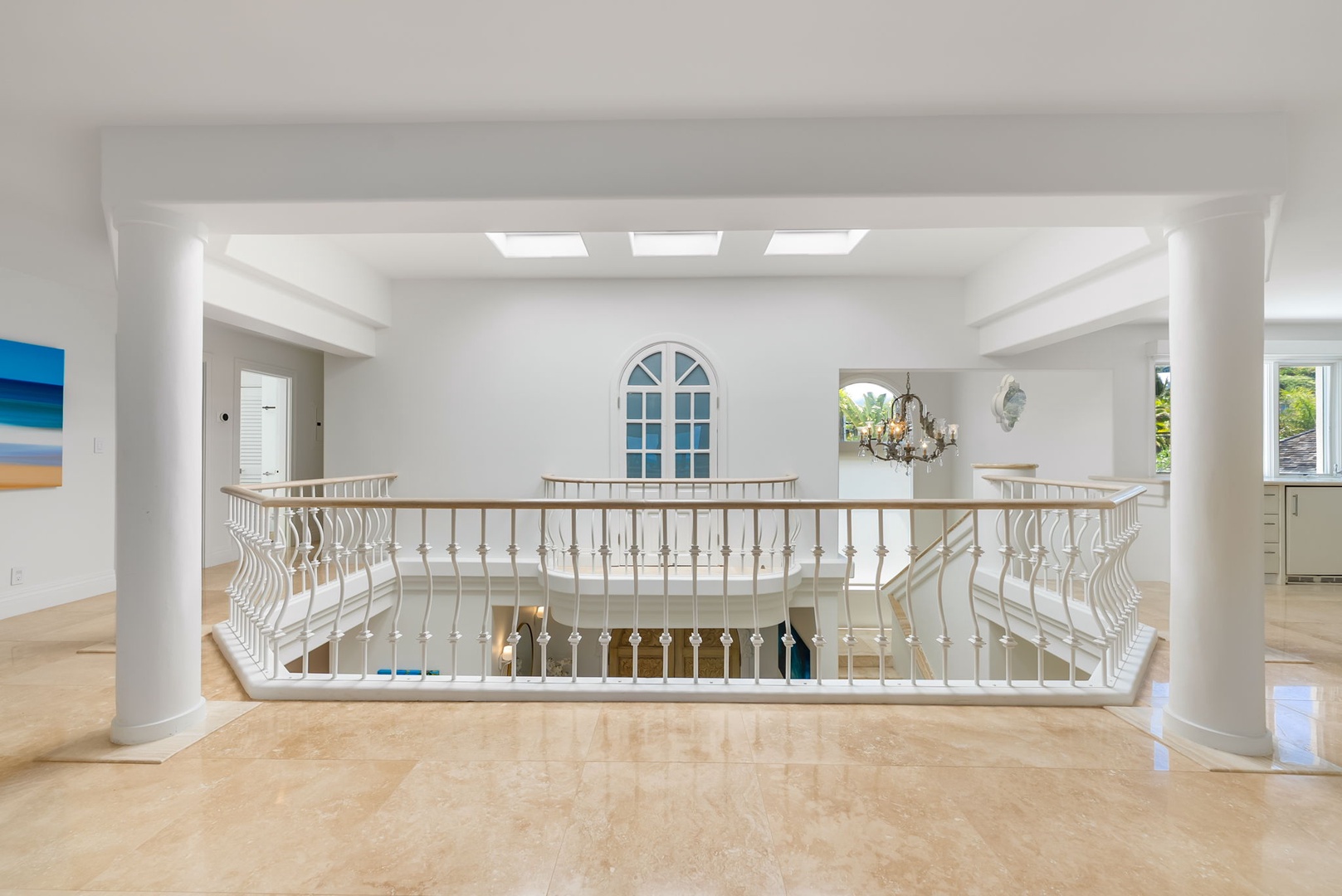 Kailua Vacation Rentals, Lanikai Sunrise Estate - Open-air atrium with skylights and balcony views creates a bright and peaceful upstairs landing.