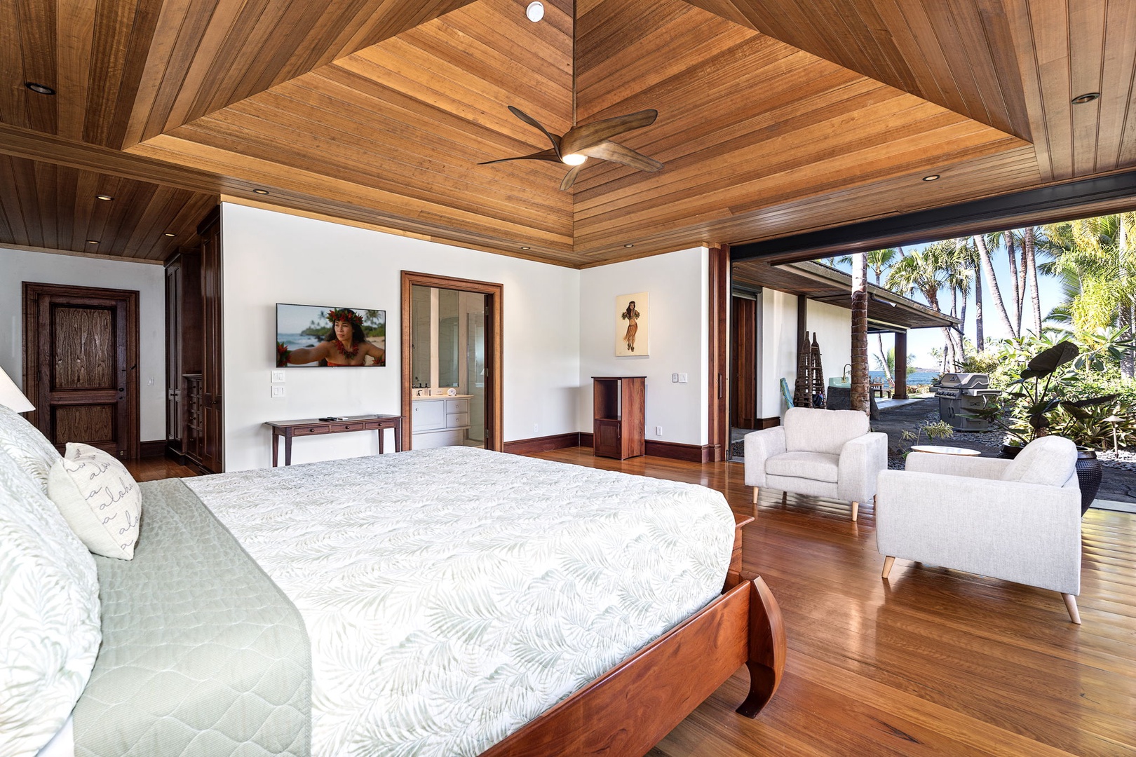 Kailua-Kona Vacation Rentals, Hahalua Bay Villa - Relax in your spacious guest suite with soaring wood ceilings, where white armchairs invite morning coffee while tropical gardens beckon just outside.