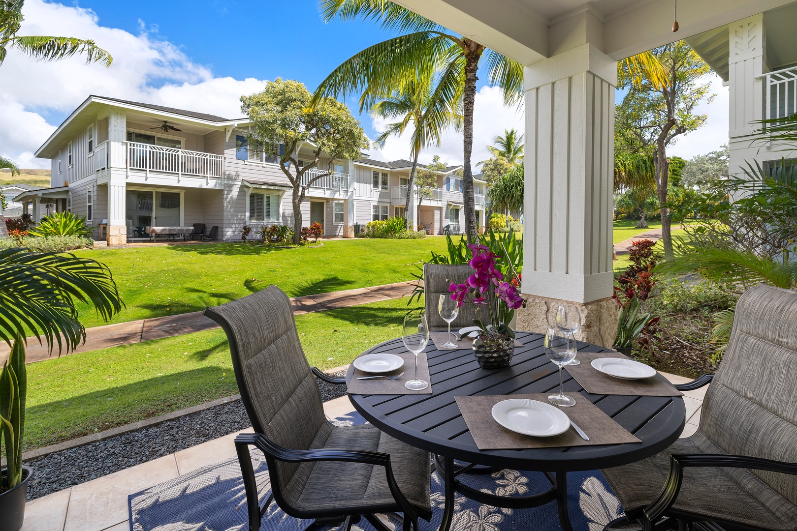 Kapolei Vacation Rentals, Ko Olina Kai 1083C - Morning coffee on the lanai under swaying palm trees.