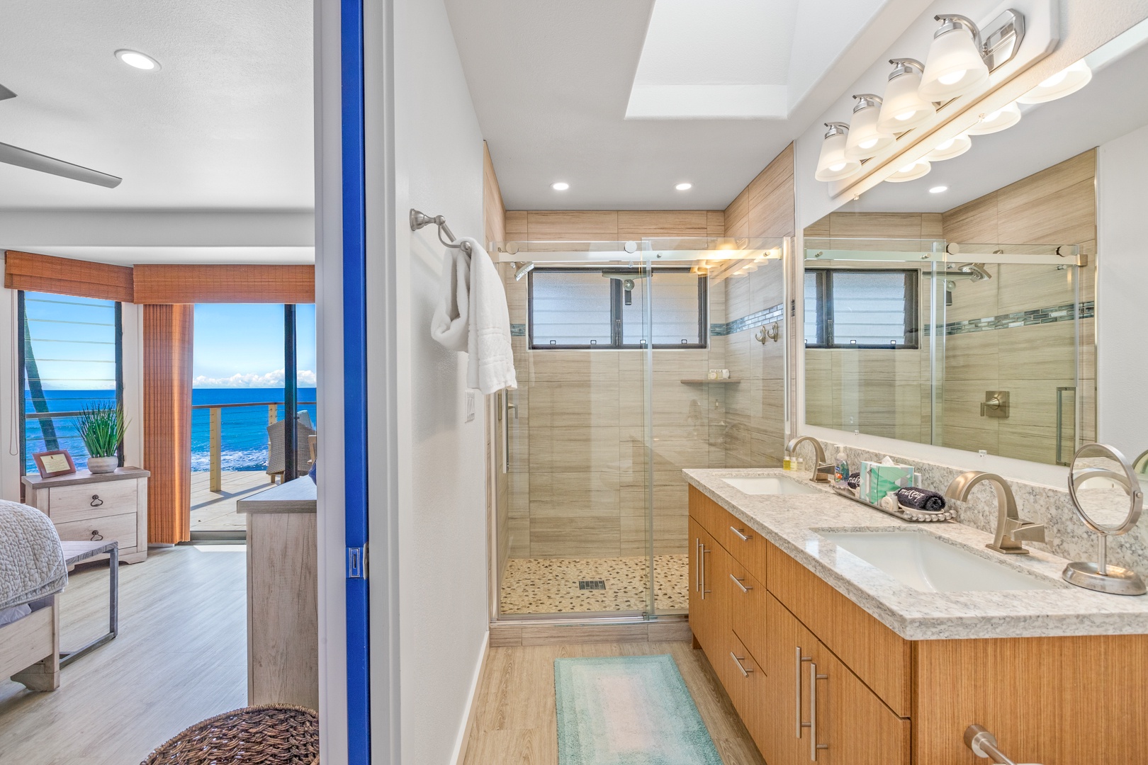 Lahaina Vacation Rentals, Puamana 254-2 - The primary ensuite bathroom at Puamana 254-2 features dual vanities and a separate shower.