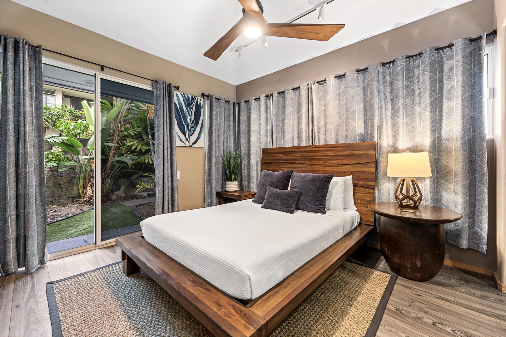 Kailua Kona Vacation Rentals, Hale Nai'a - Unwind in your serene bedroom with warm wood accents, tropical garden views, and modern comfort for peaceful sleep.