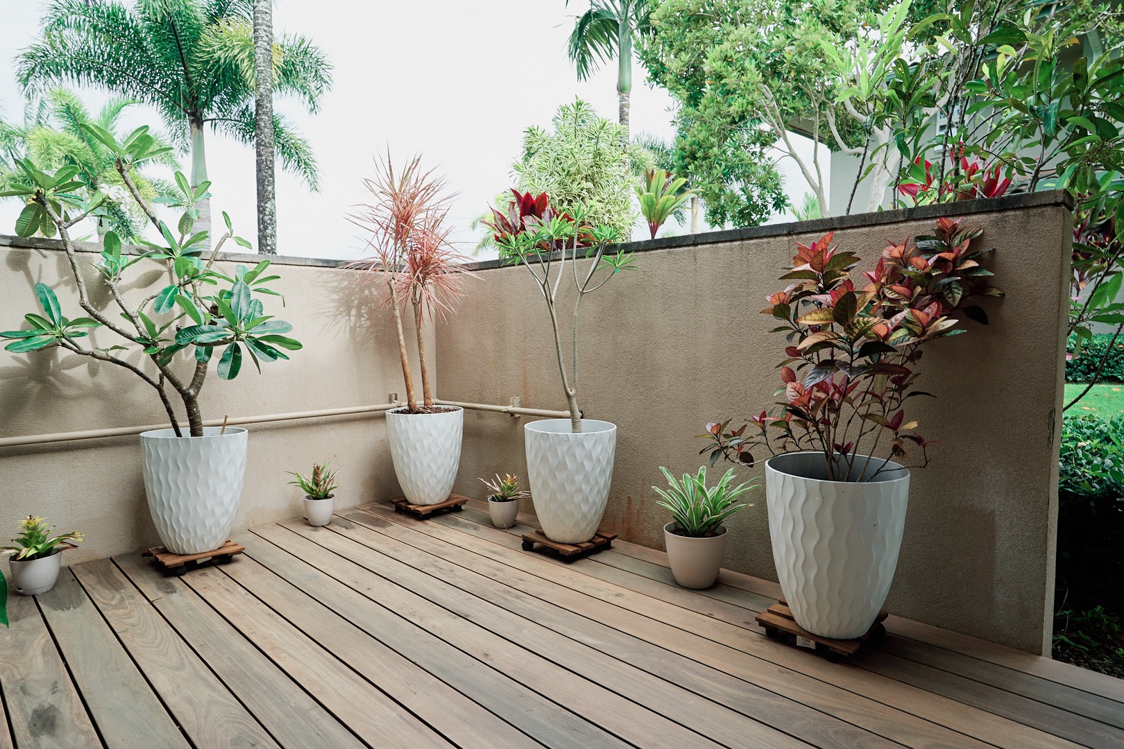 Princeville Vacation Rentals, Hale Kai - Your private deck garden retreat awaits, where tropical plants create a peaceful oasis for morning coffee or evening relaxation.