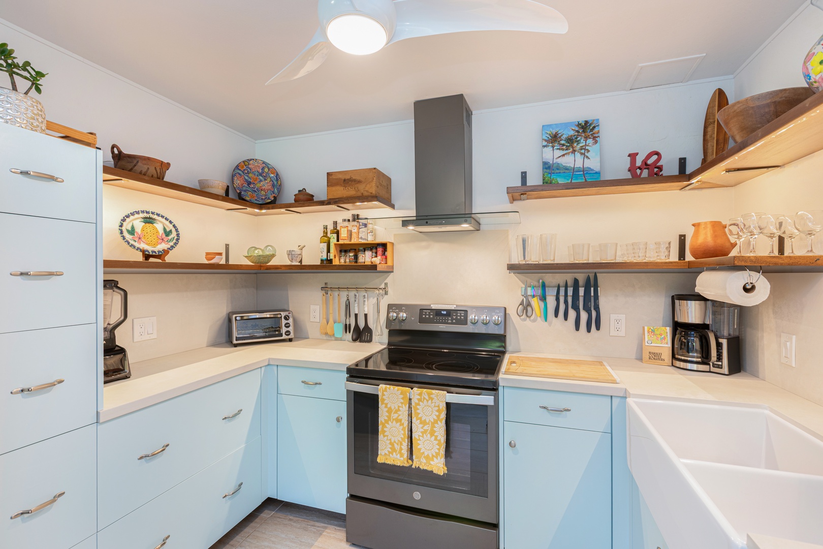 Princeville Vacation Rentals, Pohaku Kauai - Open shelving, coastal touches, and an electric range make this kitchen both stylish and functional.