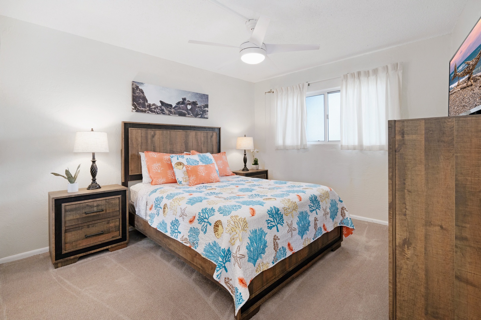 Kihei Vacation Rentals, Menehune Shores 316 - Matching lamps flank the queen bed, a TV in the corner for the nights you stay in.