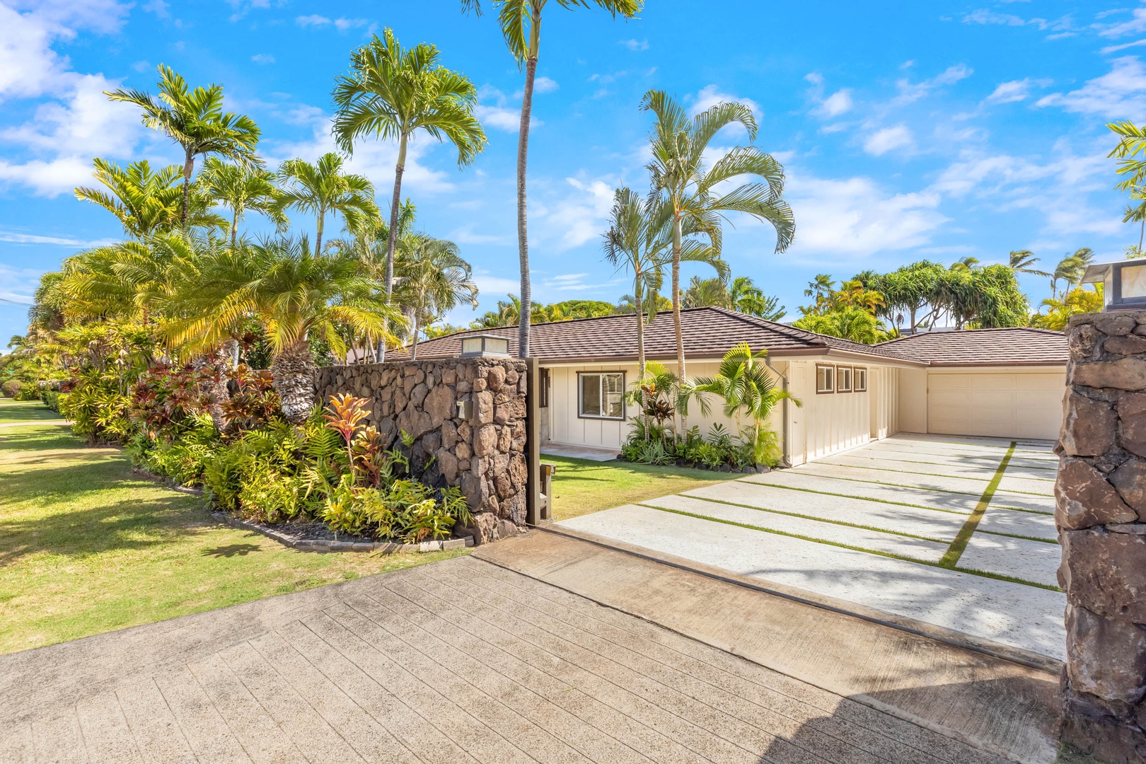 Honolulu Vacation Rentals, Kahala Breeze - Welcoming home entrance with tropical landscaping and a spacious driveway.