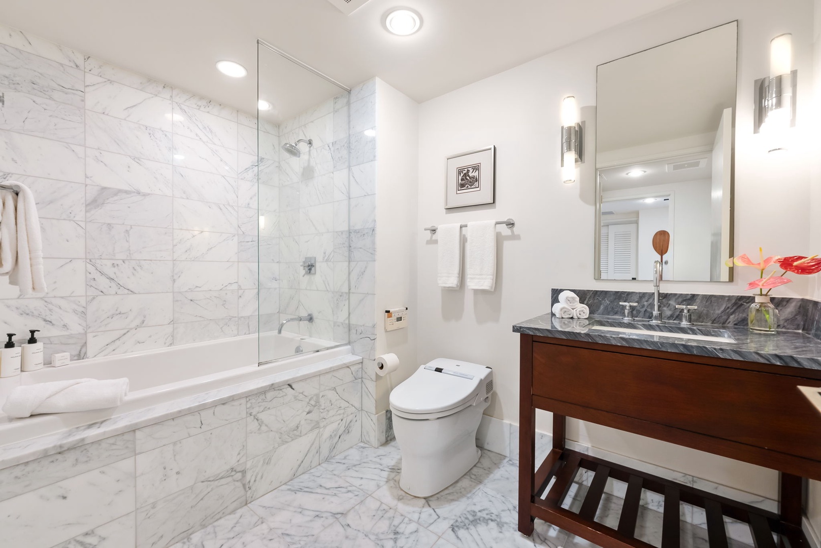 Honolulu Vacation Rentals, Kala'i 3203 - Modern 3rd guest bathroom featuring sleek marble finishes, a soaking tub, and elegant vanity.