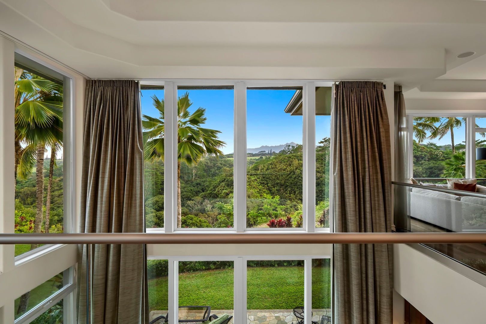 Princeville Vacation Rentals, Kaiulani #8 - Look out from the upstairs windows over the lawn and the green beyond it.