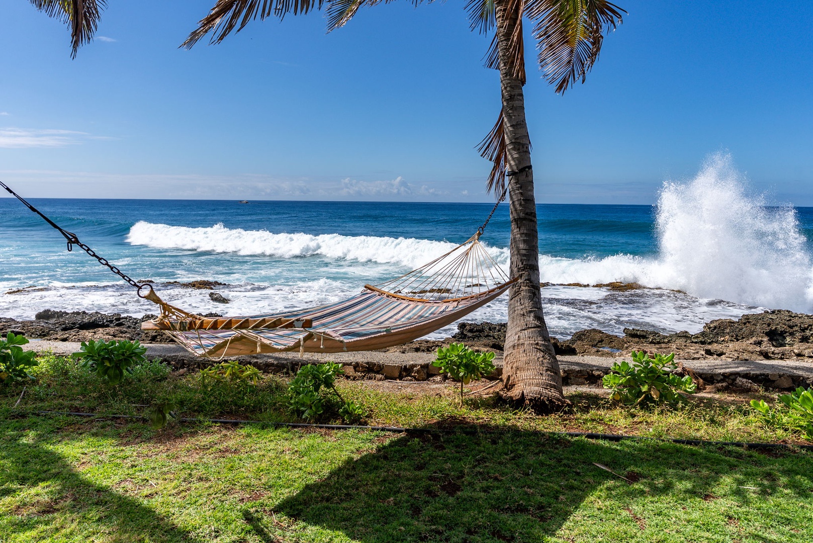 Waianae Vacation Rentals, Oceanfront Luxury Dream Estate - This shaded hammock perch offers front-row views of the surf, framed by coconut palms.