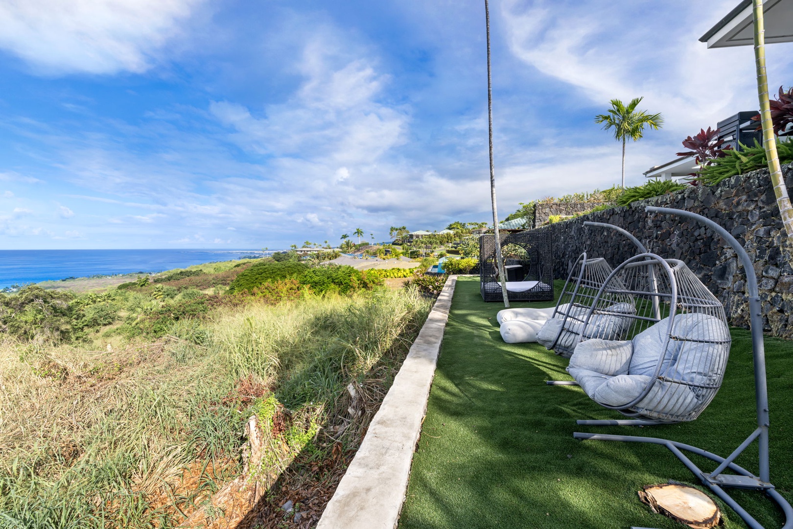 Kailua Kona Vacation Rentals, Hale Nai'a - Swing gently in your private hanging chairs while soaking up stunning ocean views and tropical breezes from this peaceful terrace.