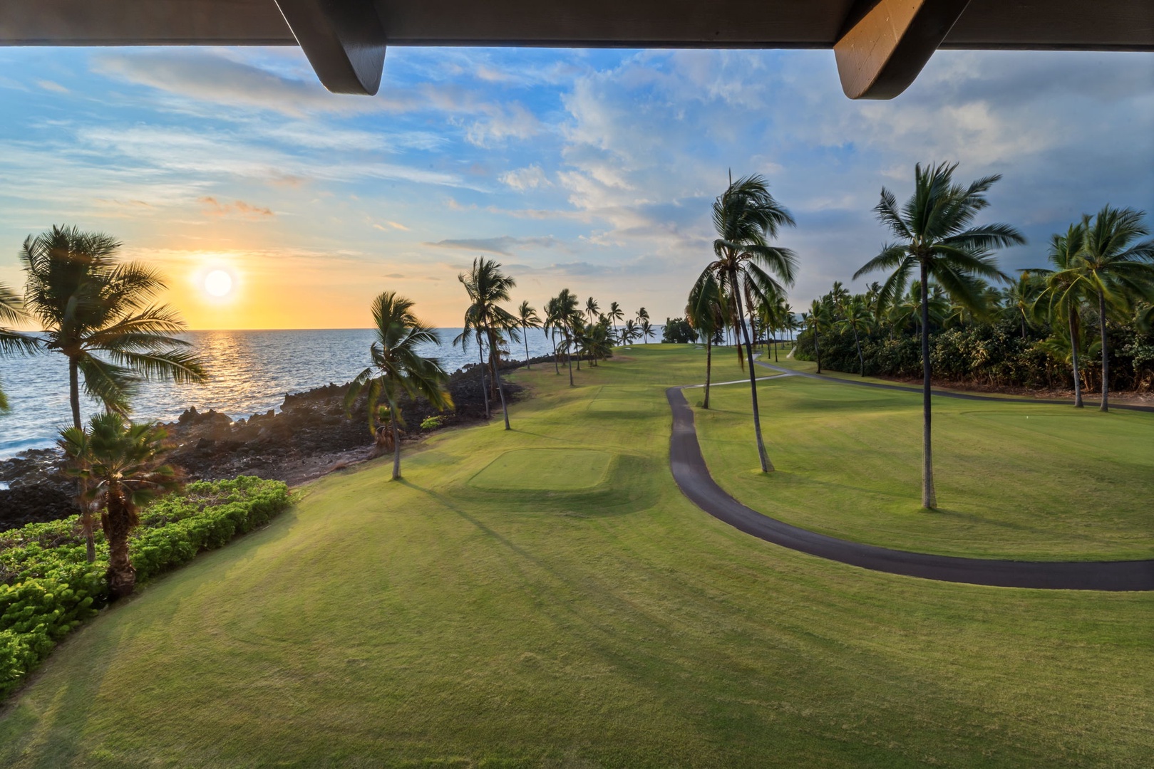 Kailua Kona Vacation Rentals, Kanaloa at Kona 1606 - The fairway empties out at sunset, palms throwing long shadows across the grass.