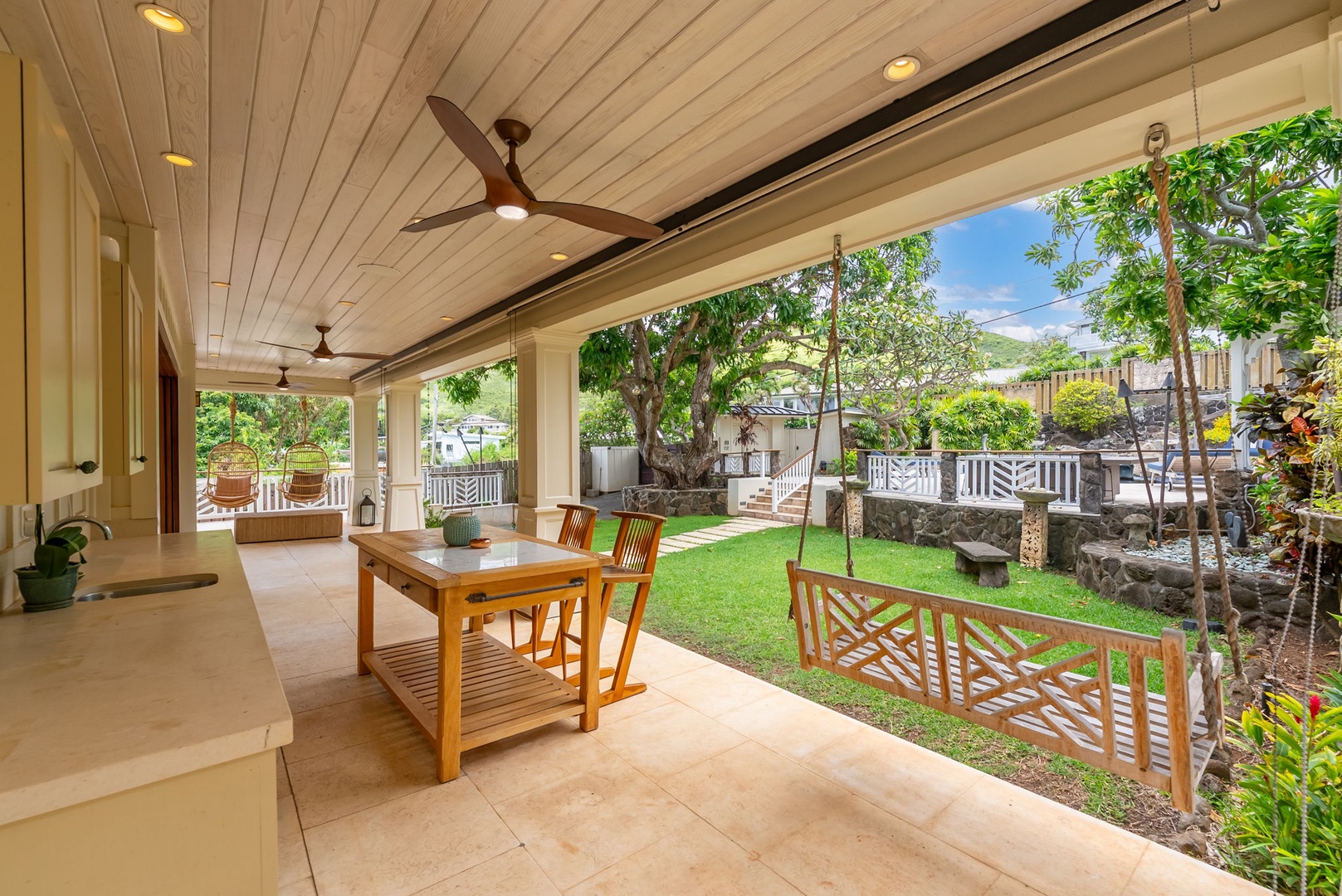 Kailua Vacation Rentals, Leaf House - Step onto your private covered lanai with ceiling fans, where warm island breezes meet peaceful garden views. Relax at the teak table, swing gently in the hammock, and savor outdoor living surrounded by lush greenery and tropical charm.