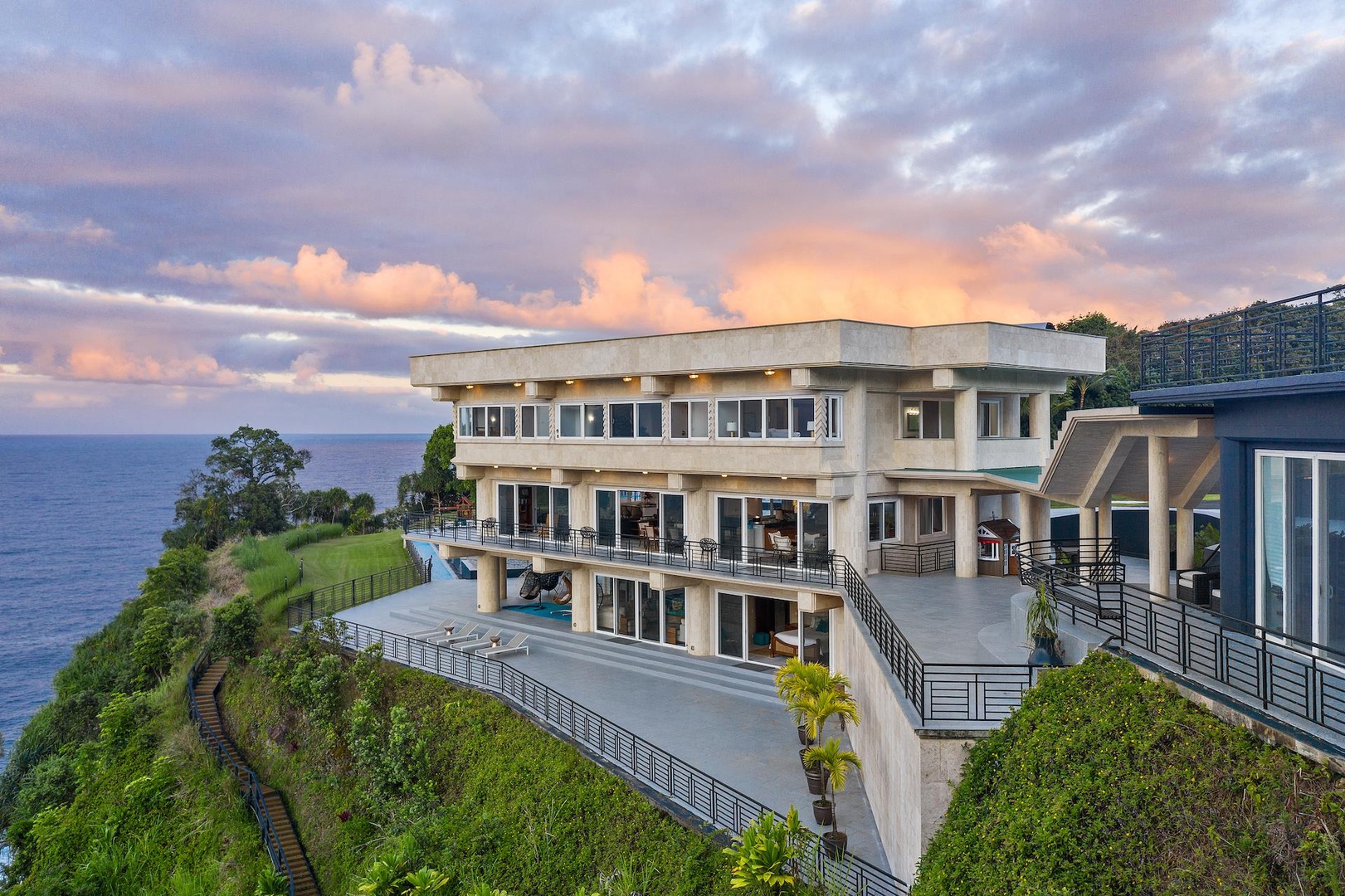 Ninole Vacation Rentals, Waterfalling Estate** - Wraparound decks on the first and second levels offer truly tropical indoor/outdoor living.