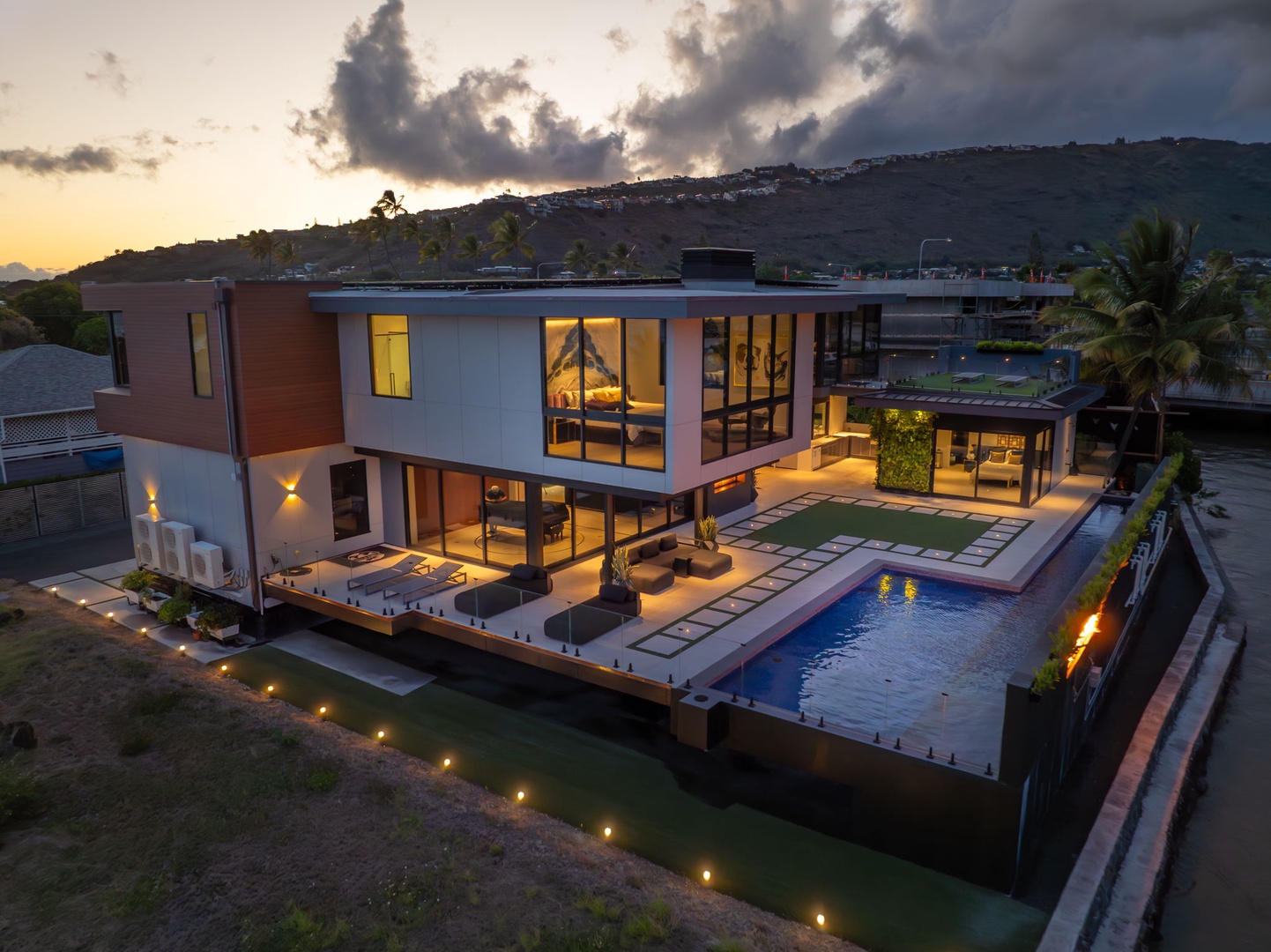 Honolulu Vacation Rentals, Ocean Villa Emilie - Golden hour highlights the villa’s elevated position and open-air design—luxury from every angle.
