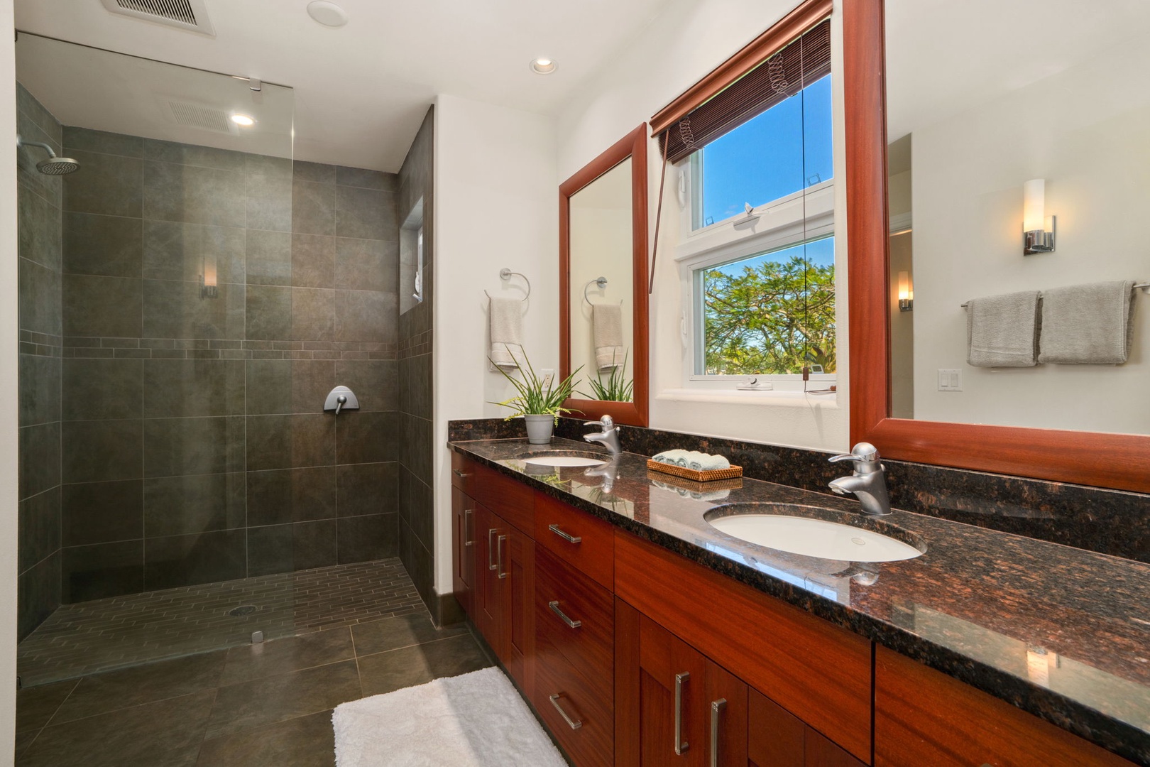 Princeville Vacation Rentals, Kaiulani #8 - Walk-in shower behind glass, and a window over the vanity to get ready in daylight.