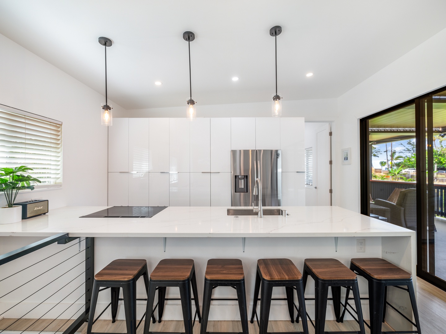 Haleiwa Vacation Rentals, Sunset Beach Island Retreat - The modern pendant lights add a warm glow, highlighting the clean lines and stainless steel appliances that complete the contemporary look