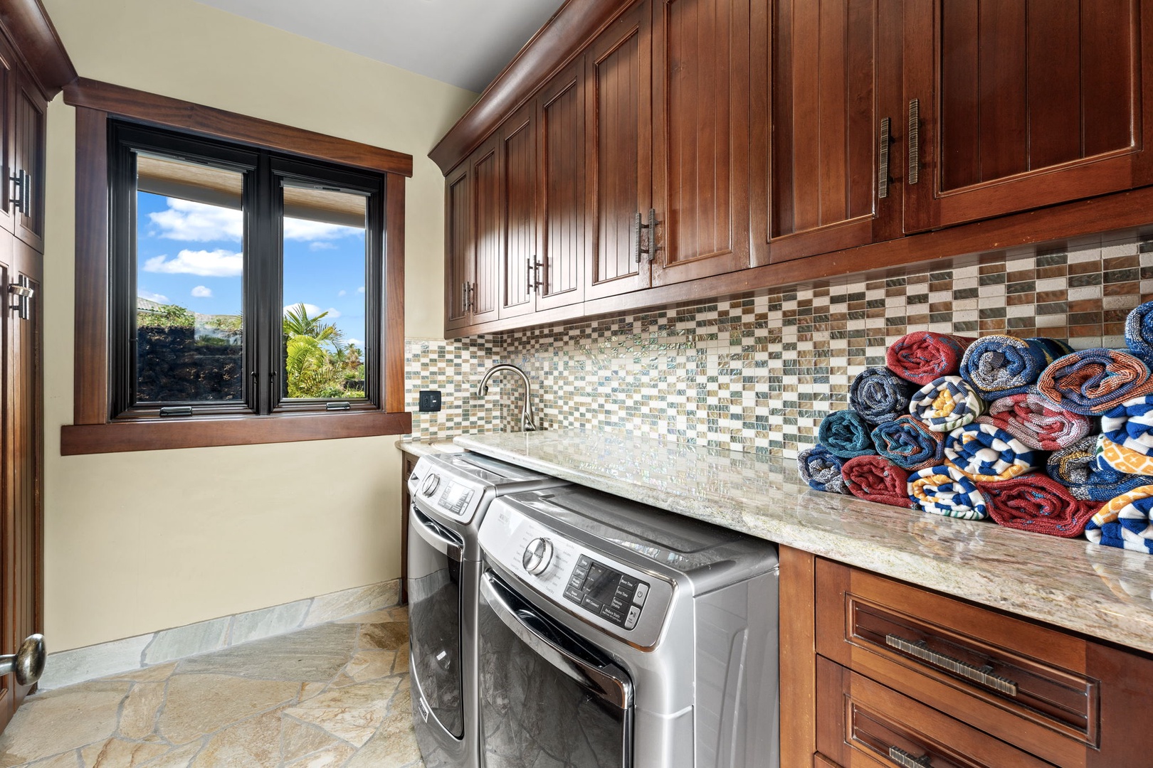 Kamuela Vacation Rentals, Hale Konane - A fully equipped laundry room with a washer, dryer, and ample storage for convenience.