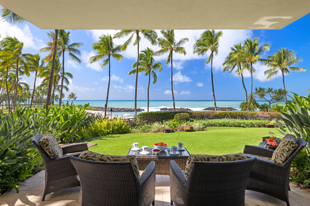 Kapolei Vacation Rentals, Ko Olina Beach Villas B109 - Enjoy your morning coffee in this serene outdoor seating area, with stunning views of the ocean and palm trees.