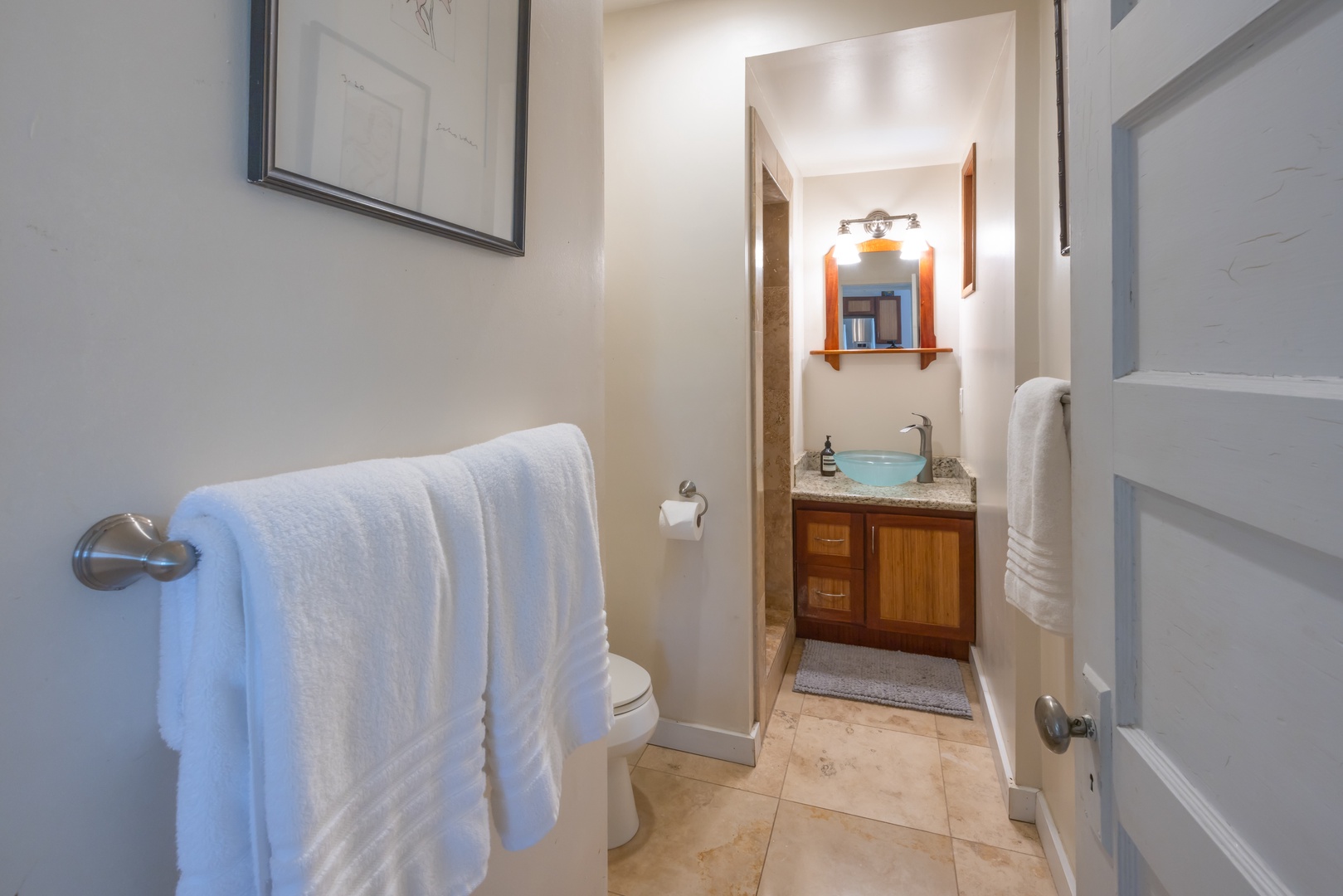 Kahuku Vacation Rentals, Hale Pellicano - The ensuite bathroom area has a single vanity and separate shower.