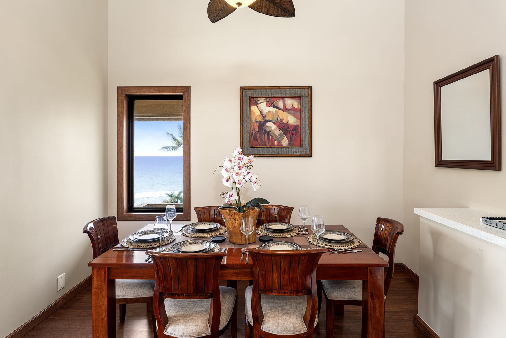 Kailua Kona Vacation Rentals, Royal Kahili 401A - Elegant dining setup for six with stylish decor and a window view for natural light.