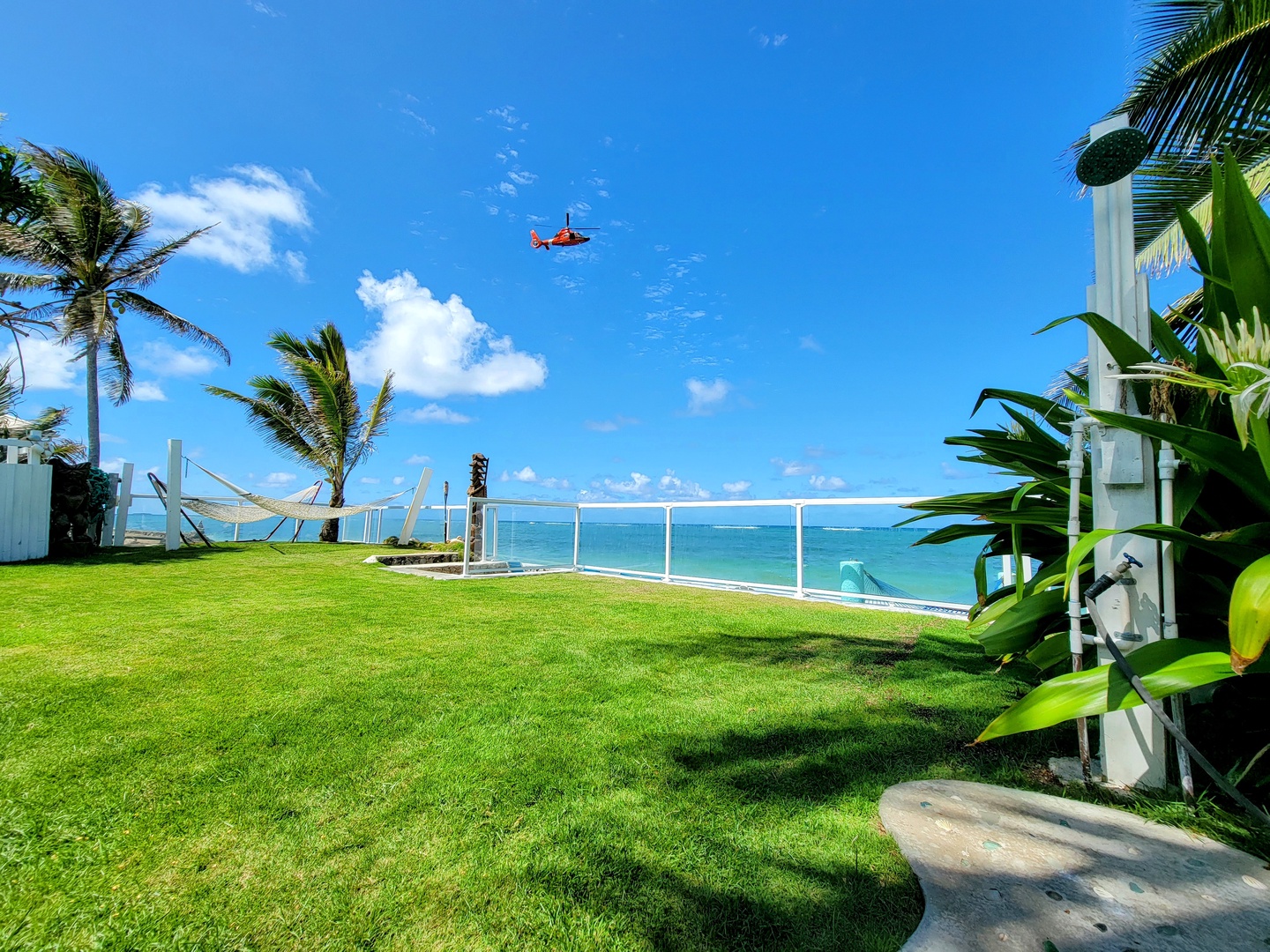 Hauula Vacation Rentals, Private Beach Paradise - Soak up the island sunshine on the expansive oceanfront lawn, where gentle trade winds and direct access to the reef invite easy days of snorkeling, lounging, and barefoot beach living.