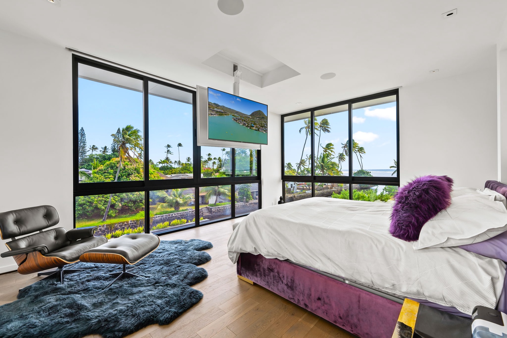Honolulu Vacation Rentals, Ocean Villa Emilie - A queen bedroom with floor-to-ceiling windows, drop-down TV and tropical views—ideal for restful nights and breezy mornings.