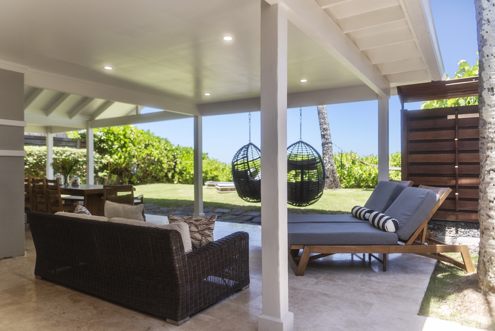 Haleiwa Vacation Rentals, Hale Nalu (Lower Level) - Unwind in the covered lanai, complete with lounge chairs, swing seats, and ocean sounds nearby.