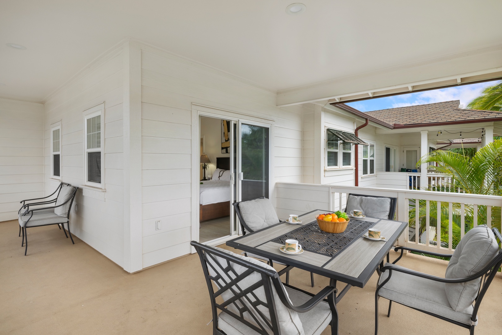 Kapolei Vacation Rentals, Coconut Plantation 1078-3 - Charming patio area connected to the second guest bedroom, ideal for relaxing with a cup of coffee.