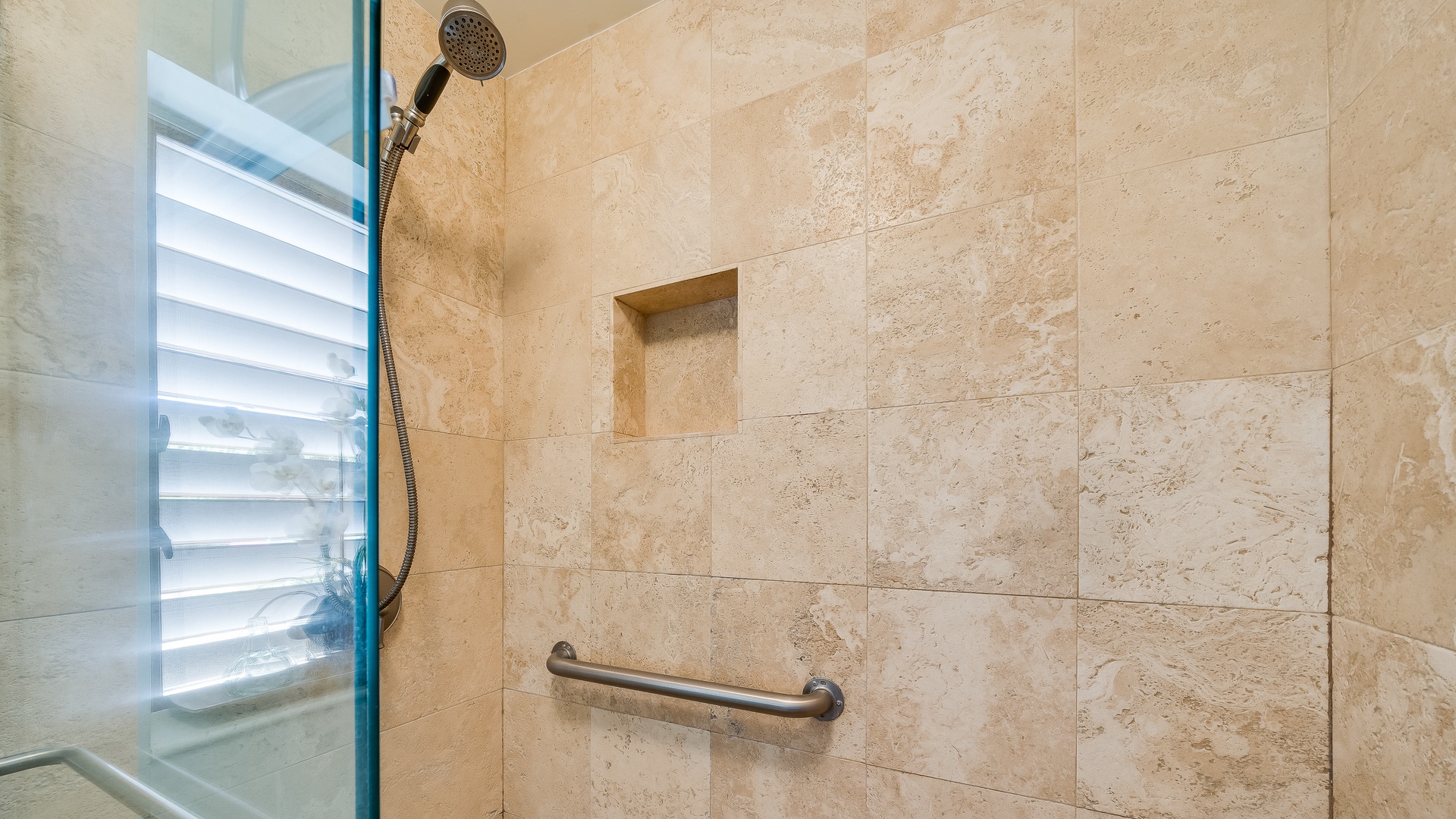 Kihei Vacation Rentals, Wailea Ekolu 1106 - The shower features a modern tiled design with a built-in nook and a handheld showerhead for added convenience.