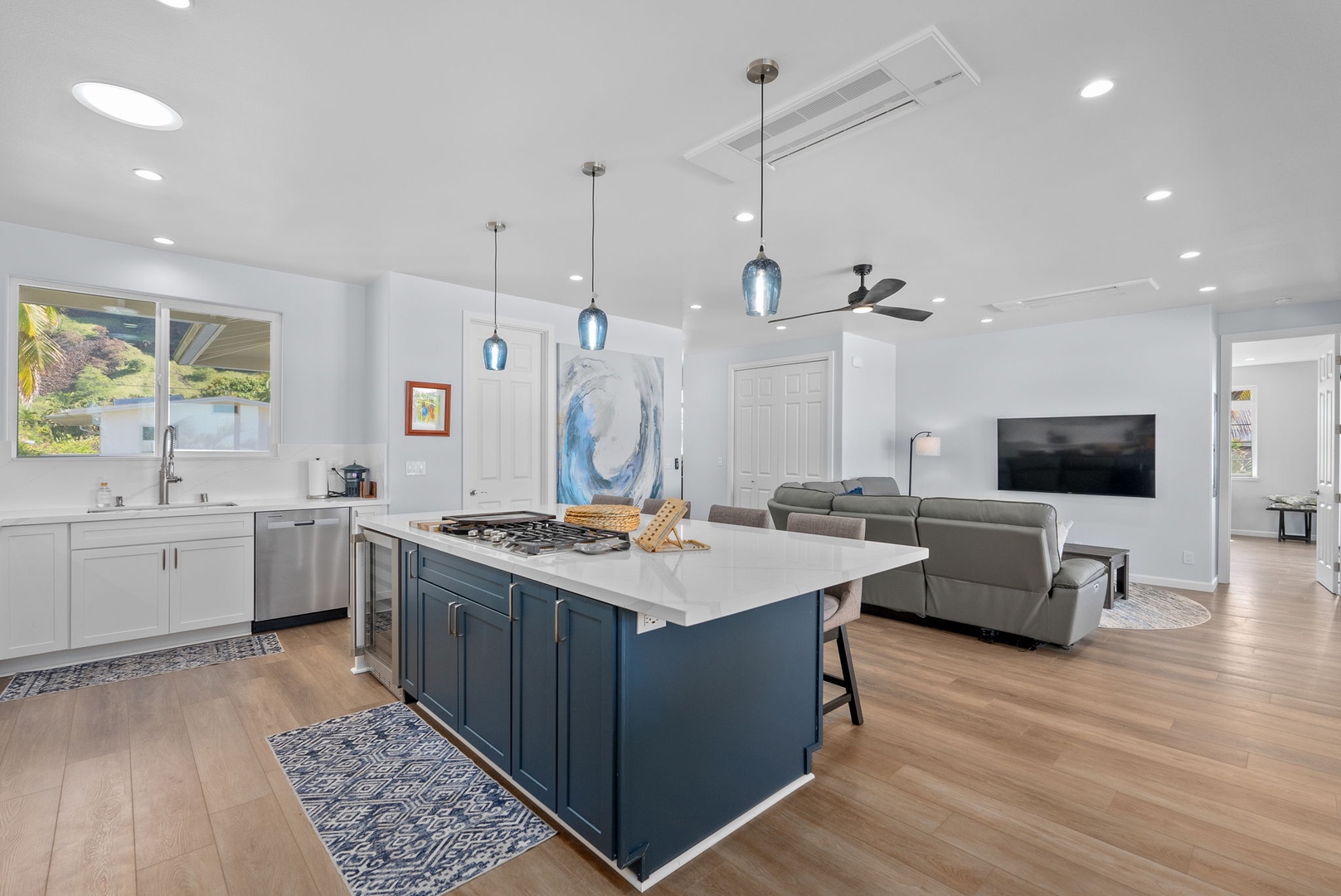 Waianae Vacation Rentals, Oceanfront Luxury Dream Estate - Upper-level kitchen with bold cabinetry, stainless steel appliances, and pendant lighting.
