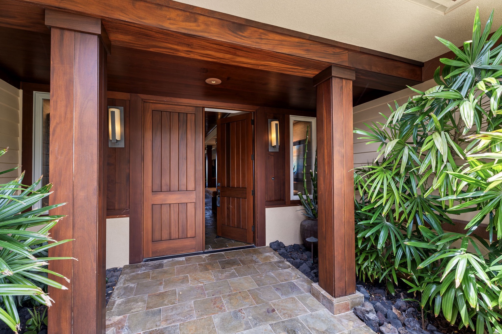 Kailua Kona Vacation Rentals, 3BD Pakui Street Estate (149) at Hualalai Resort - A koa door under deep eaves, tropical planting crowding in on both sides.